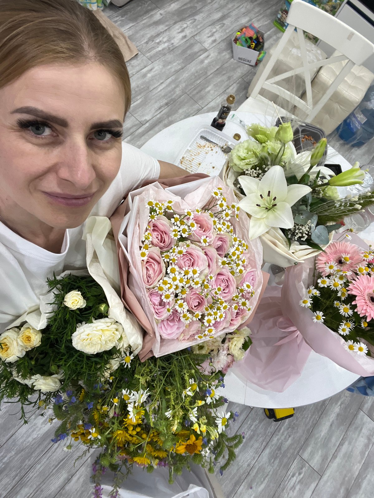 Posing with bouquets indoors in Bataysk, Russia