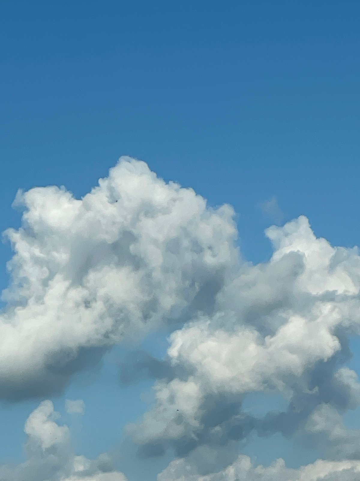Afternoon clouds form face-like pattern over Dobrich, Bulgaria