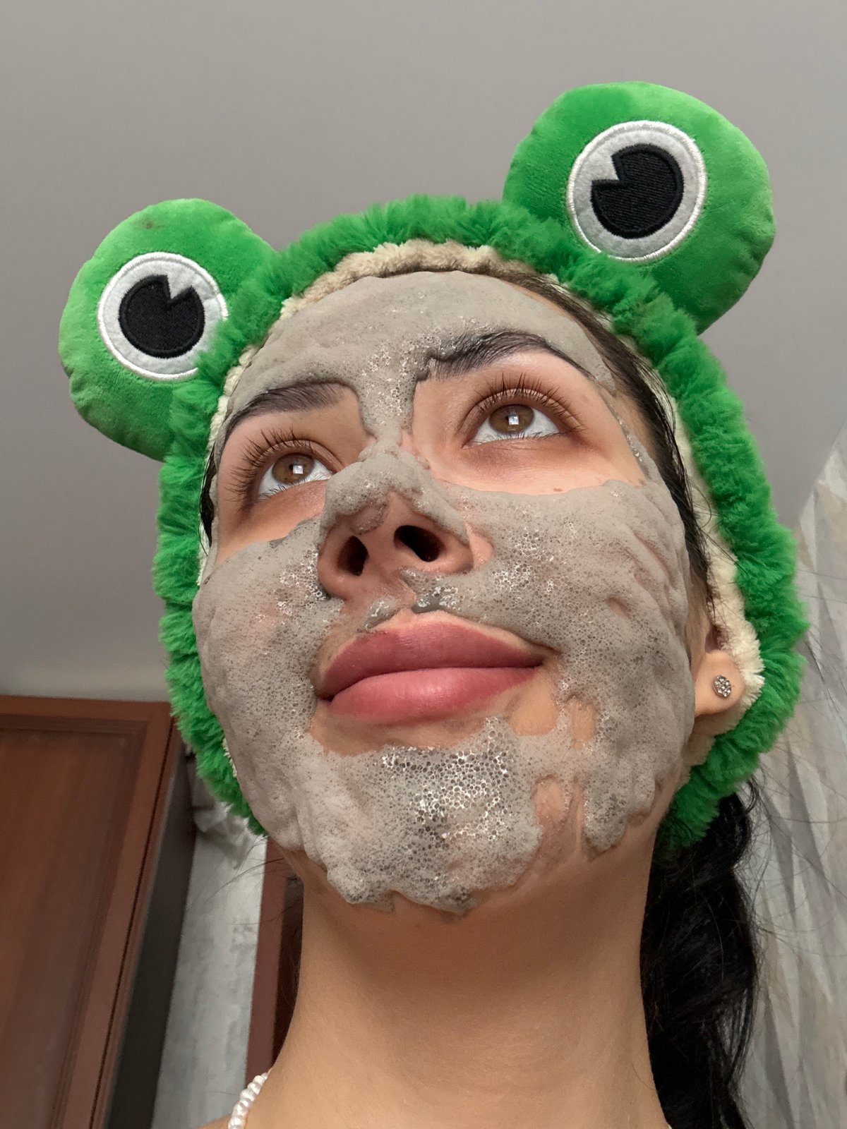 Woman poses with frog headband and face mask in Russia