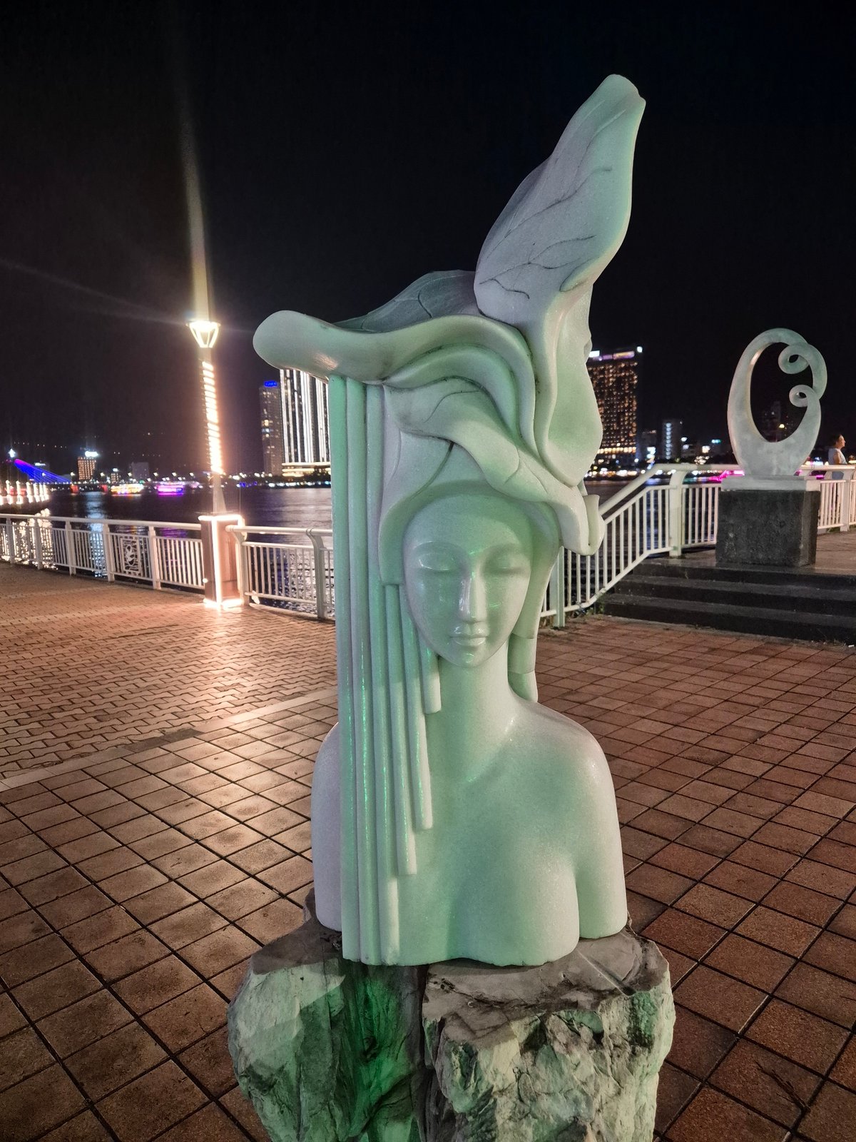 Marble sculpture collection documented along Đà Nẵng riverfront at night