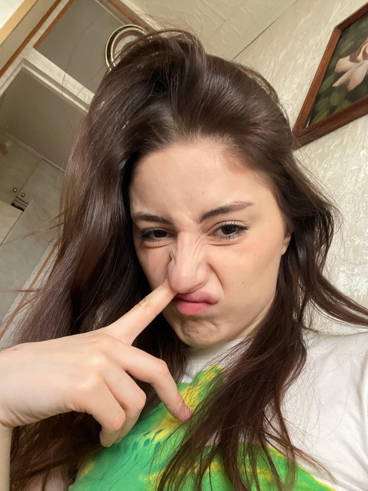 Woman takes playful selfies indoors in Moscow apartment
