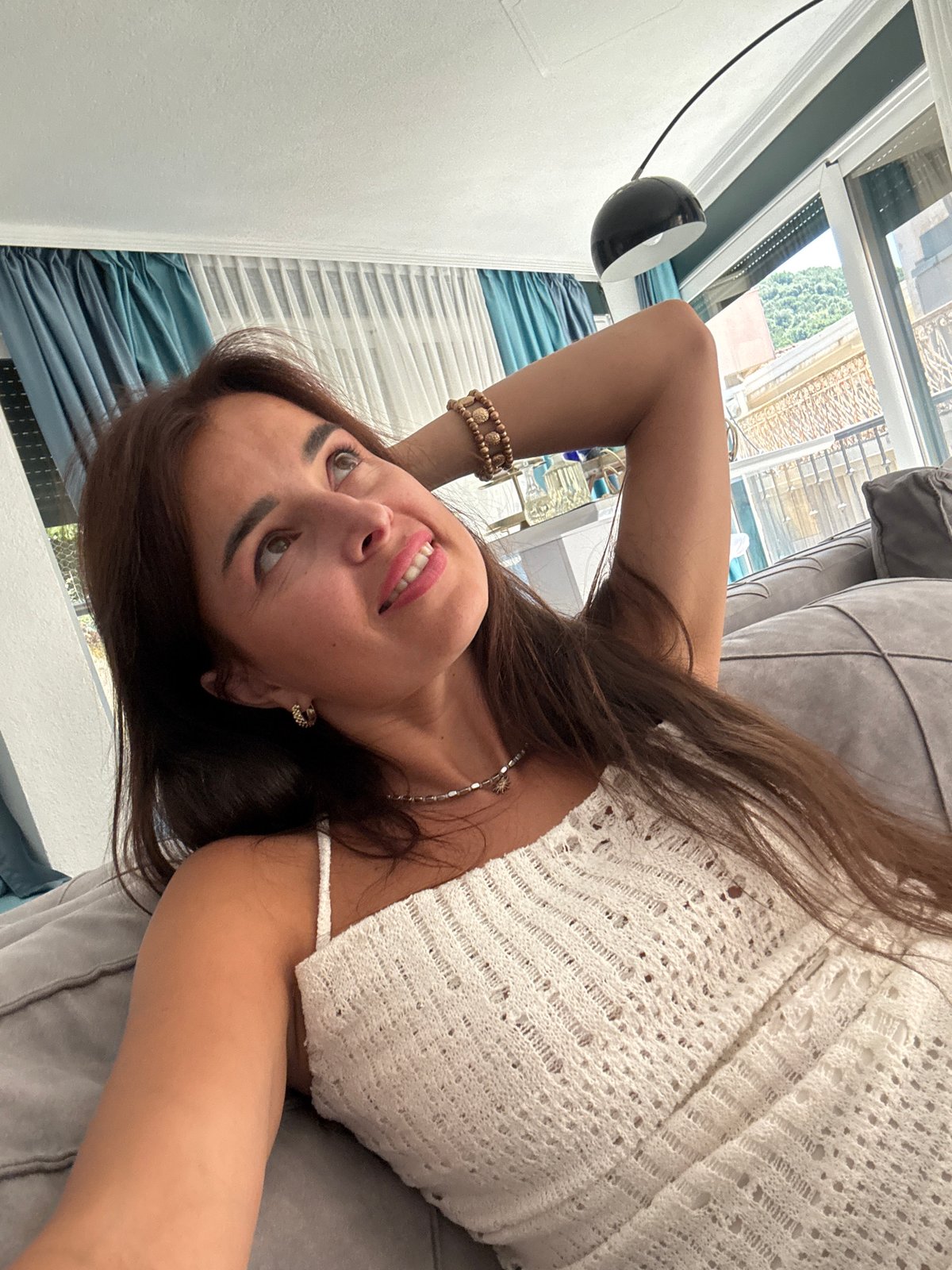 Quick home photo session on a grey sofa, white crochet top