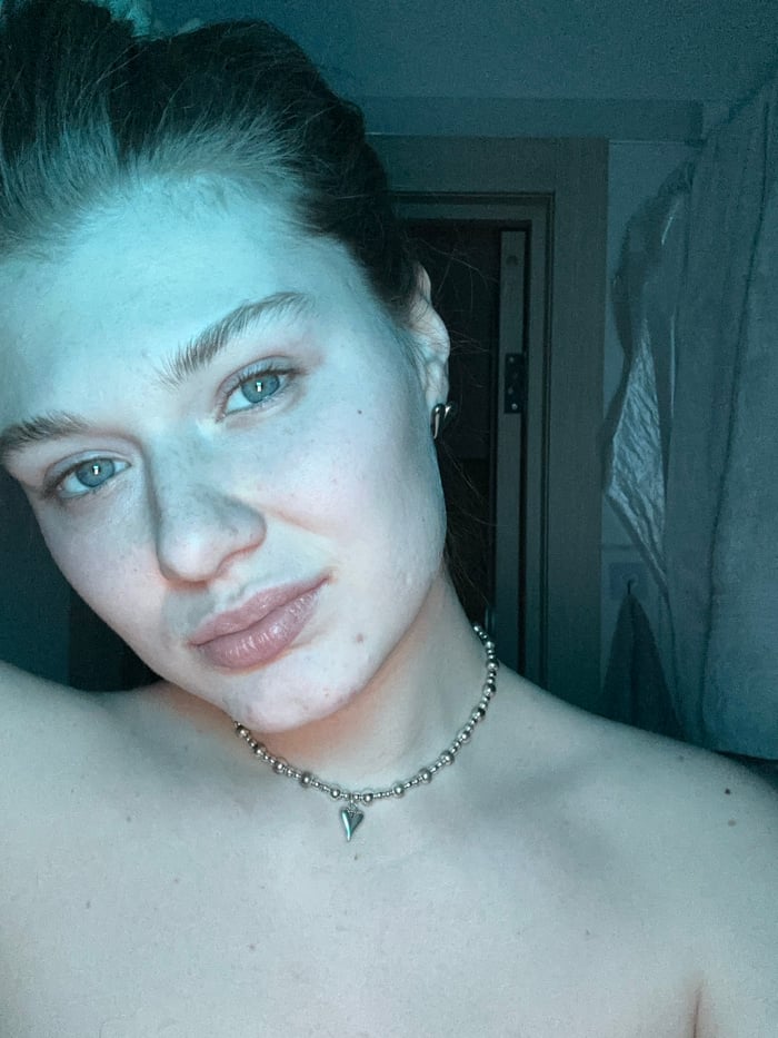 Woman photographed in red-lit indoor sessions in Noviy, Russia