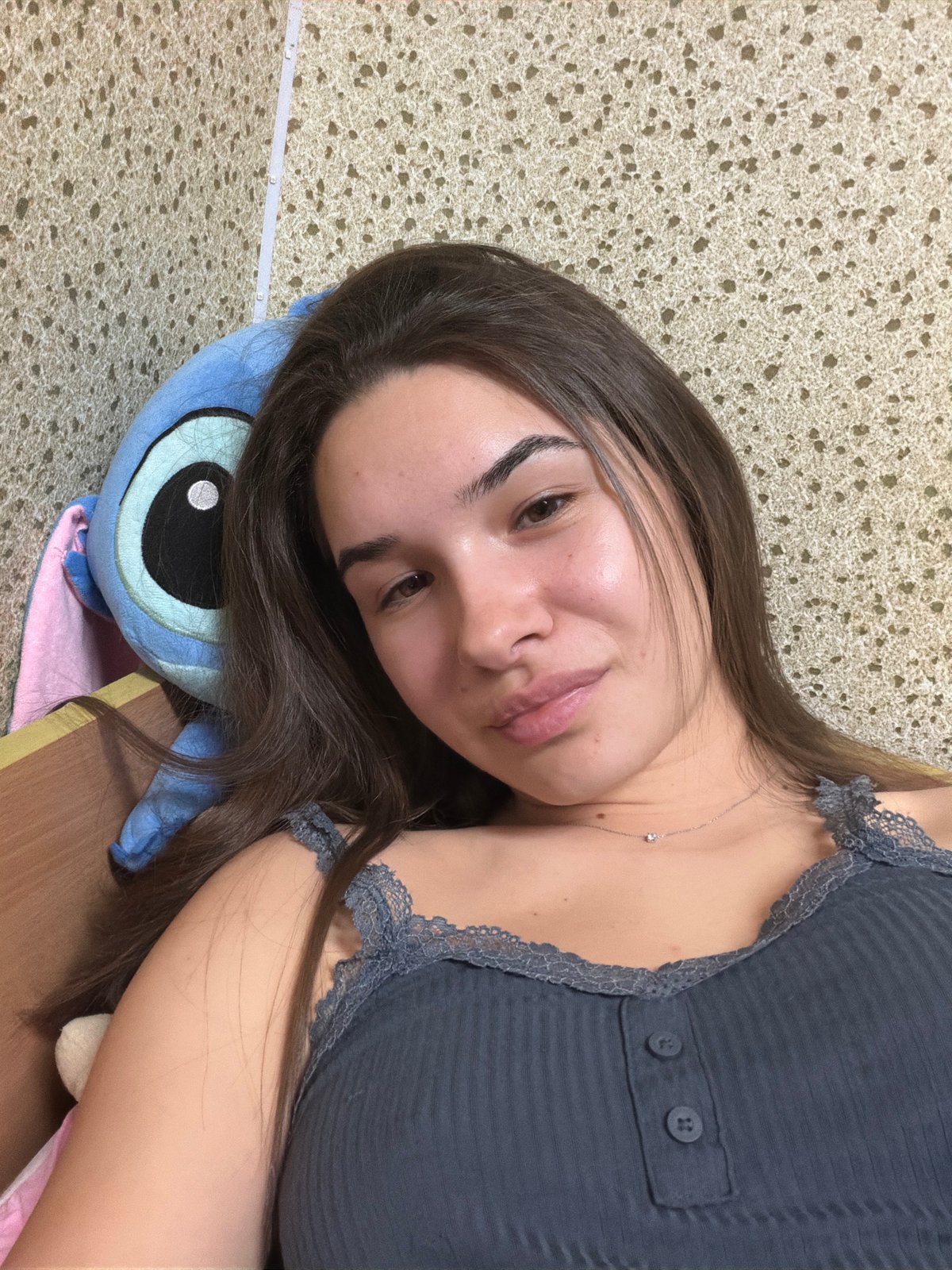 Woman resting at home with stuffed animals in Sofia