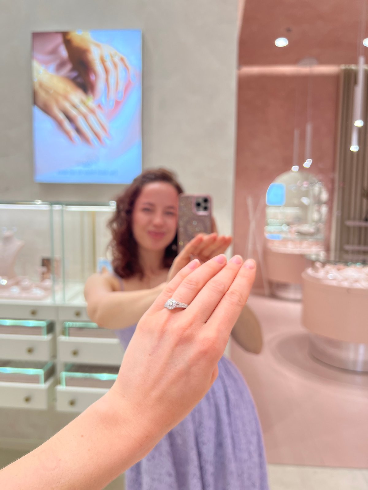 Diamond engagement ring shown off in a jewelry store