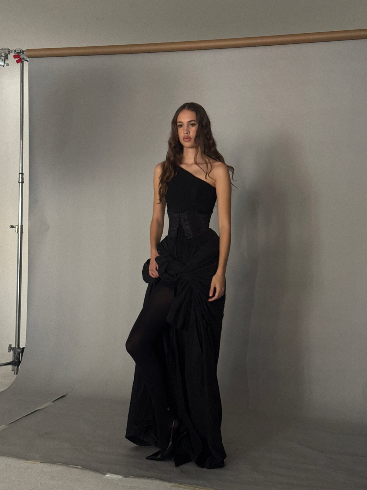 Studio fashion shoot cycling through all-black looks and accessories