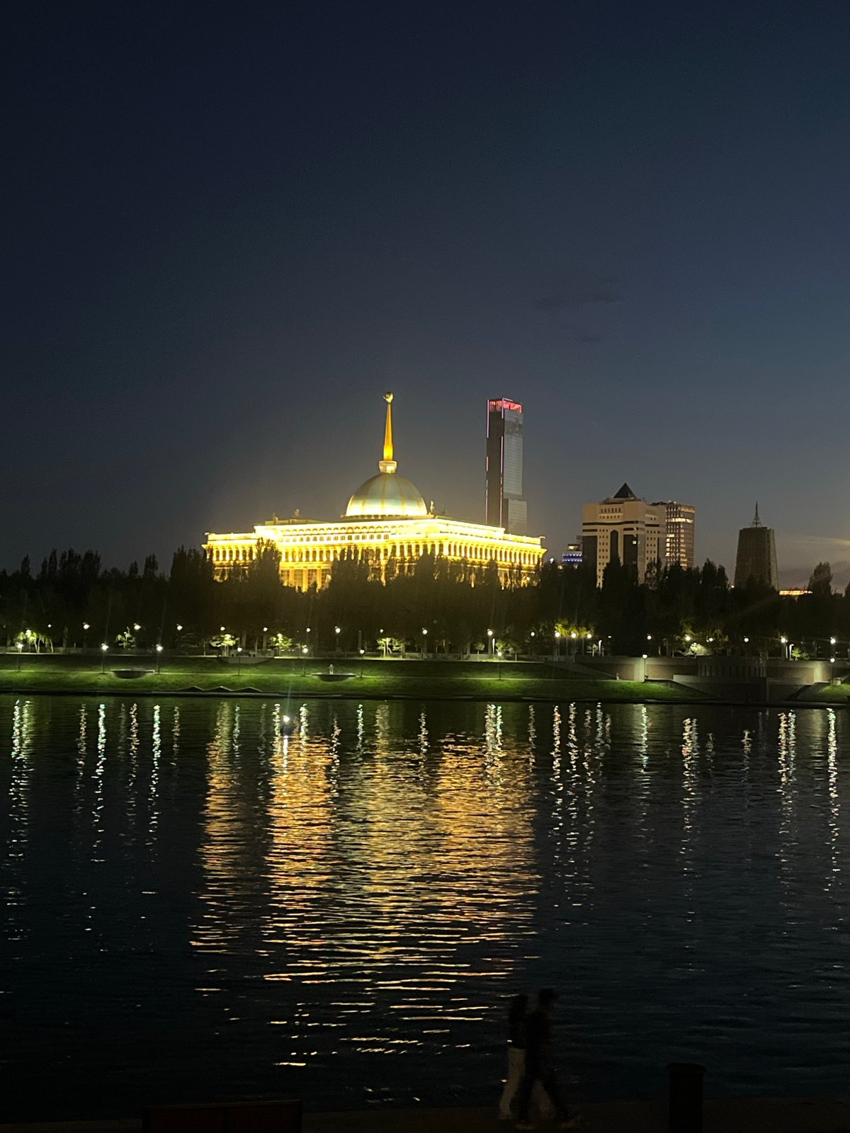 Astana at night: Bayterek monument and waterfront reflections