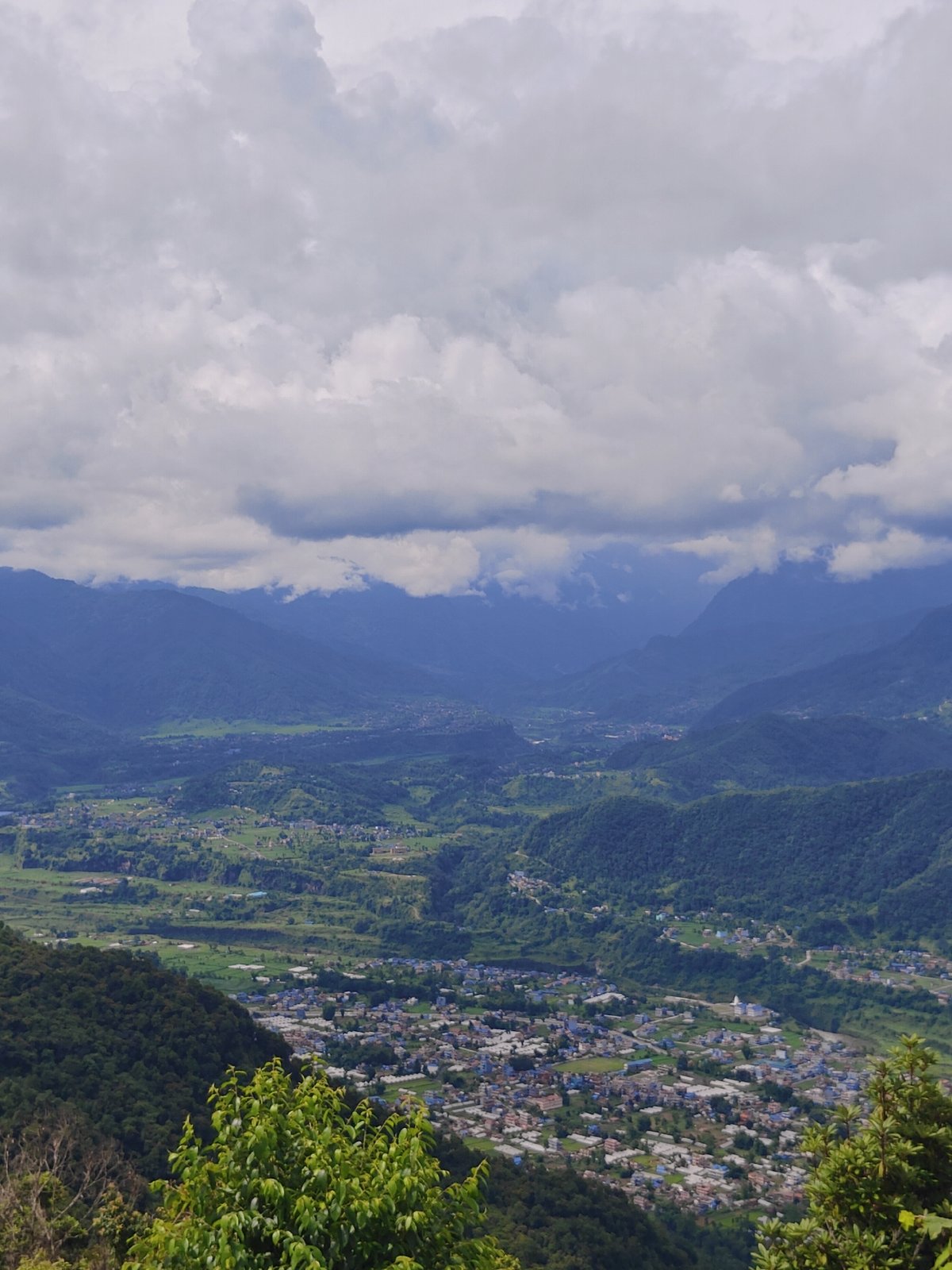 Pokhara hillsides, shrines, and valley views on a overcast morning