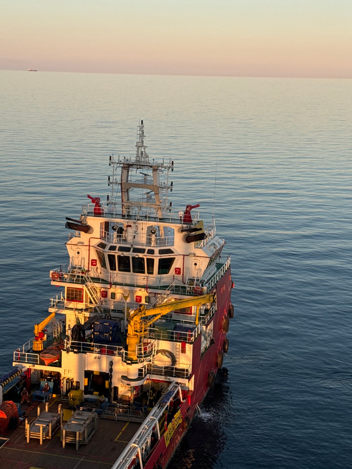 Offshore platform operations at sunset, Adriatic Sea