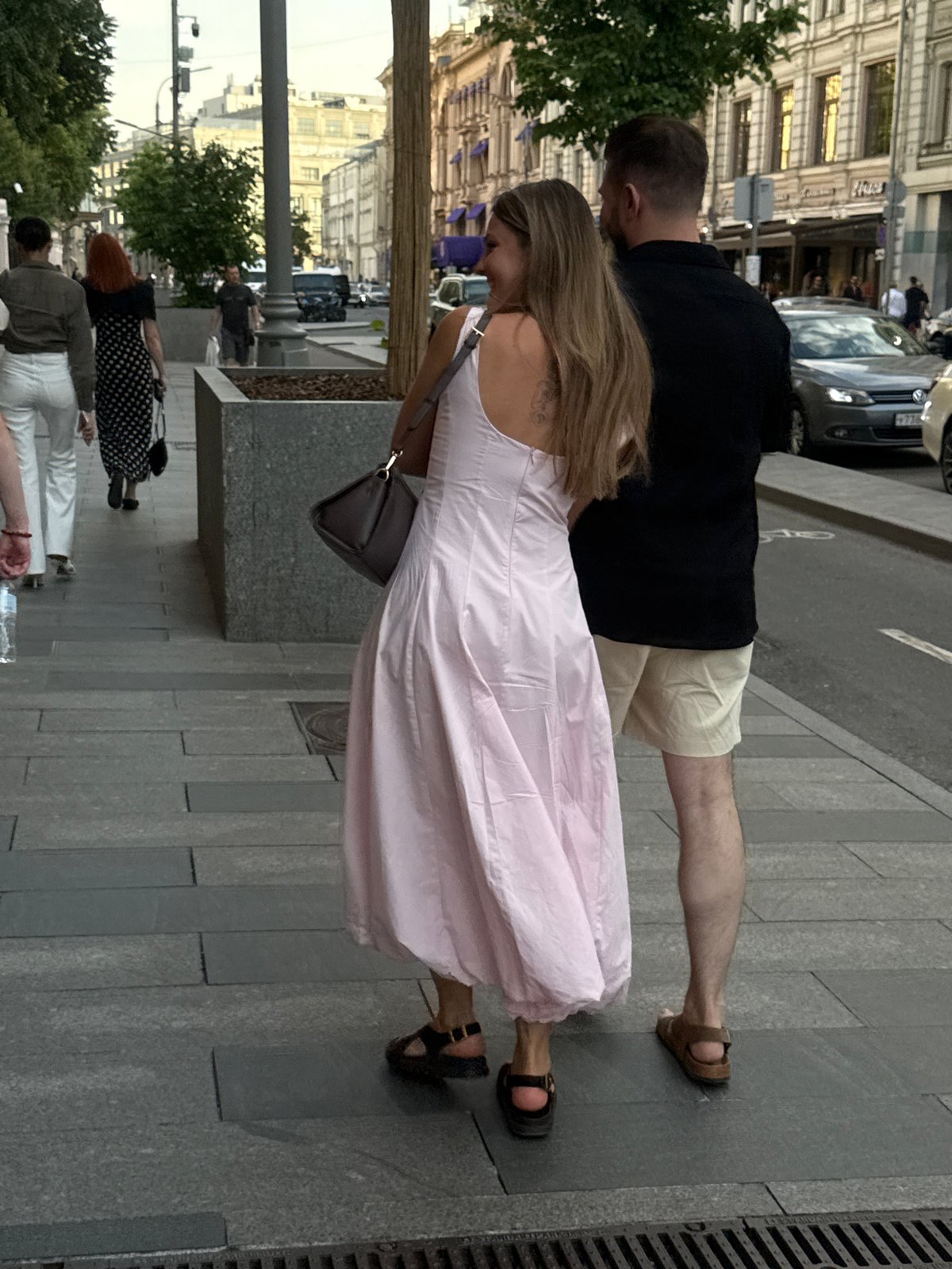 Moscow street life documented with performers, pedestrians, luxury car