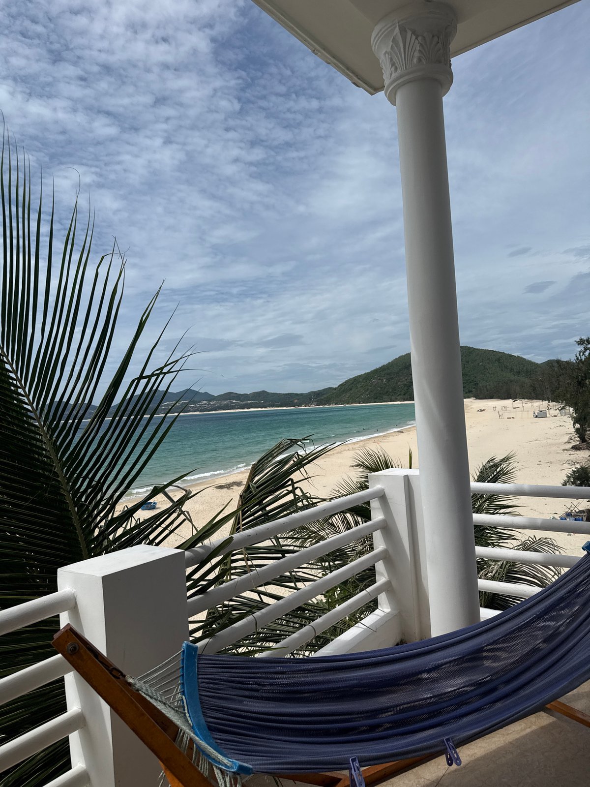 Calm tropical beach and coastline from shore and balcony