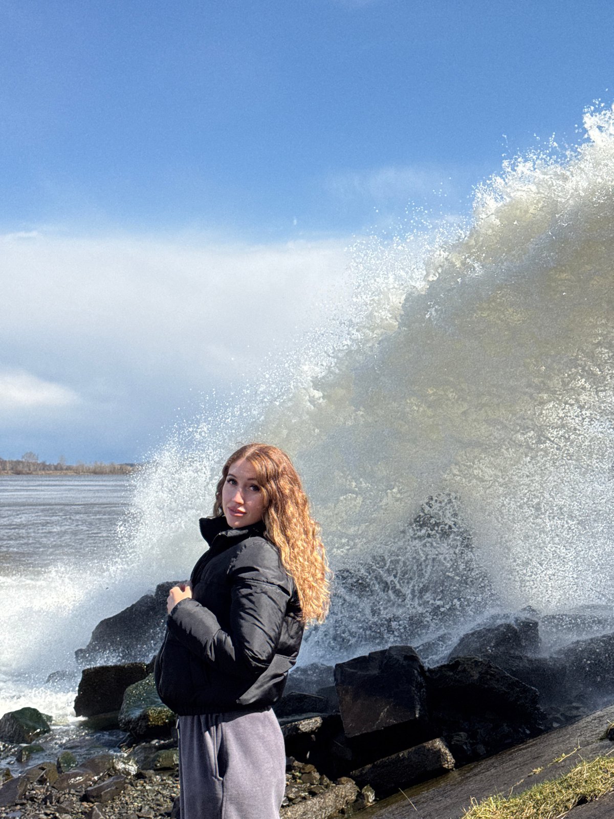 Woman visits waterfall spillway in Chernushka, Russia