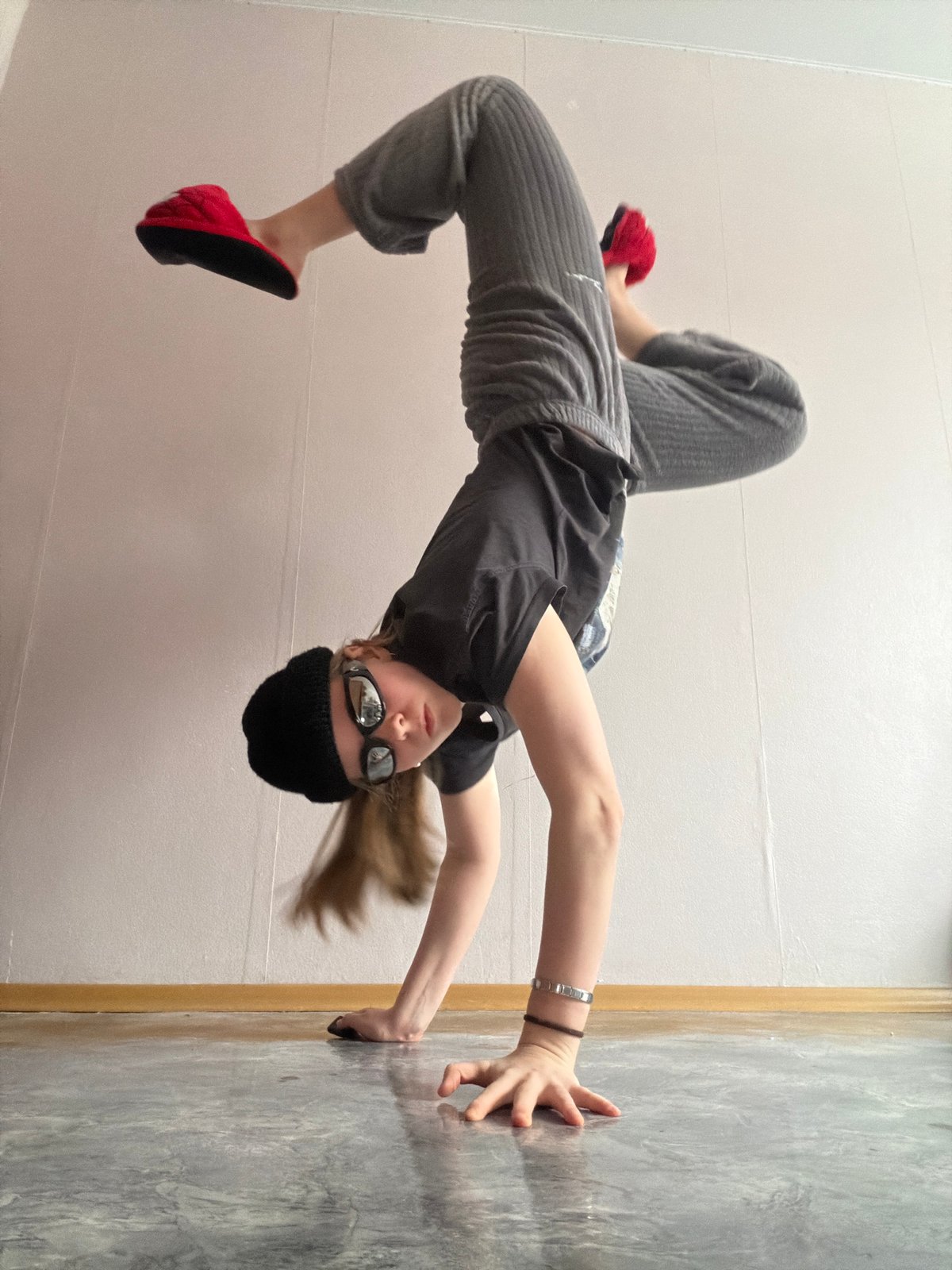 Young person performs handstands and acrobatics indoors in Perm