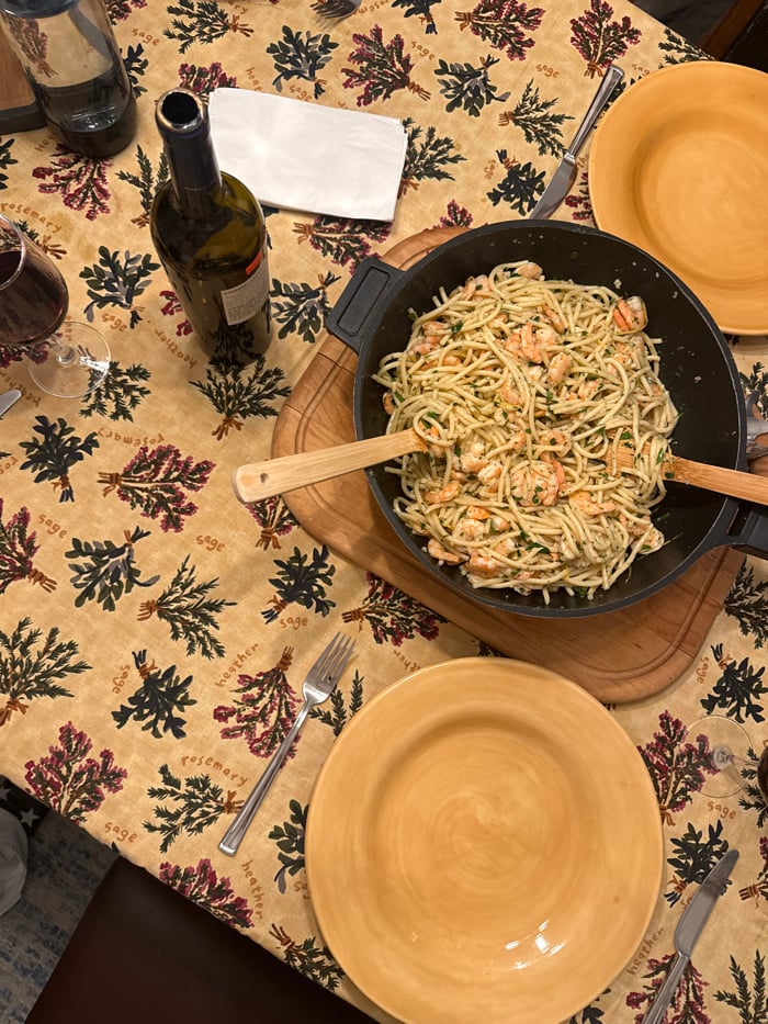 Late-night dining table set with herb-patterned tablecloth in LA