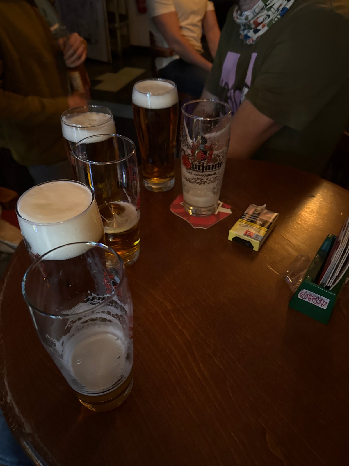 Evening social gathering at colorful glass-block bar in Trnava