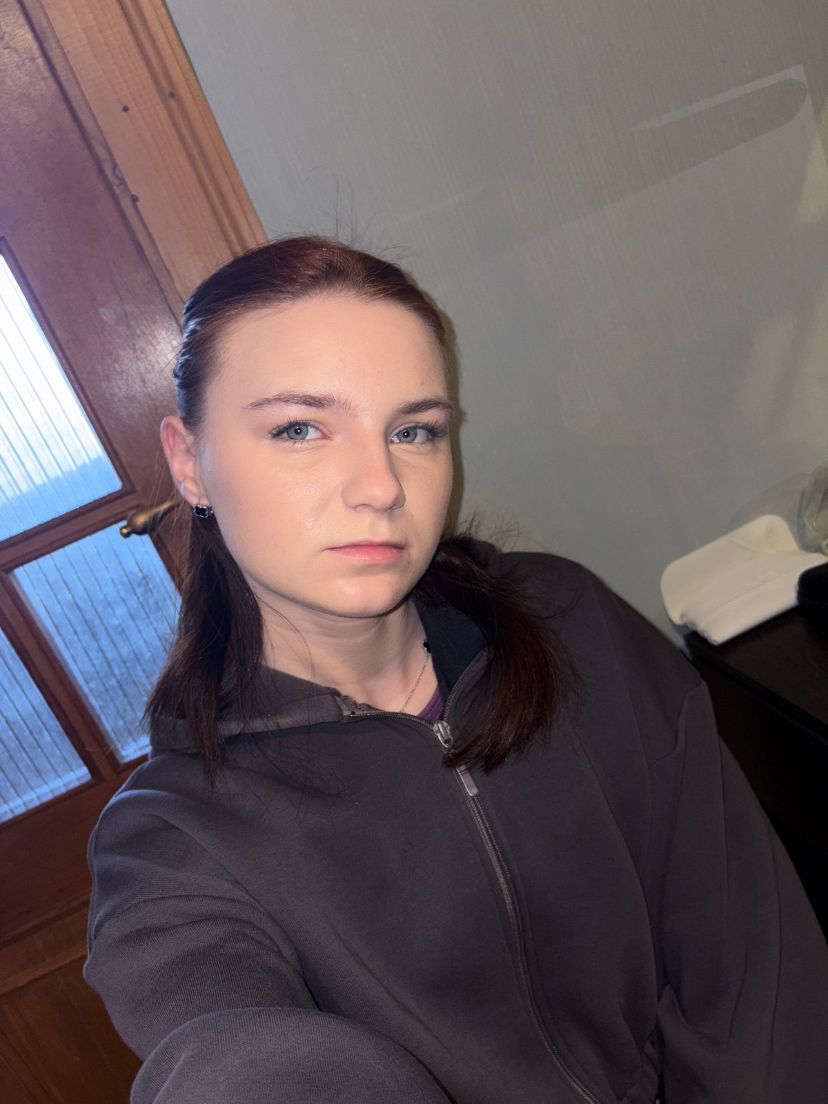 Woman in hoodie observed near window in Ladozhskoe Ozero