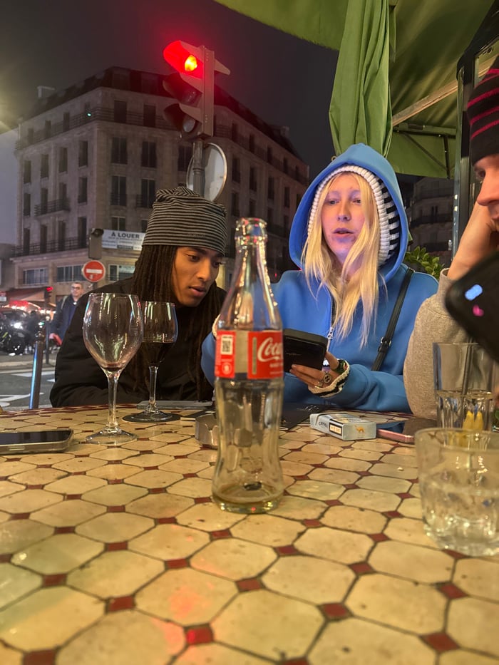 Young adults gather for evening drinks at Paris café
