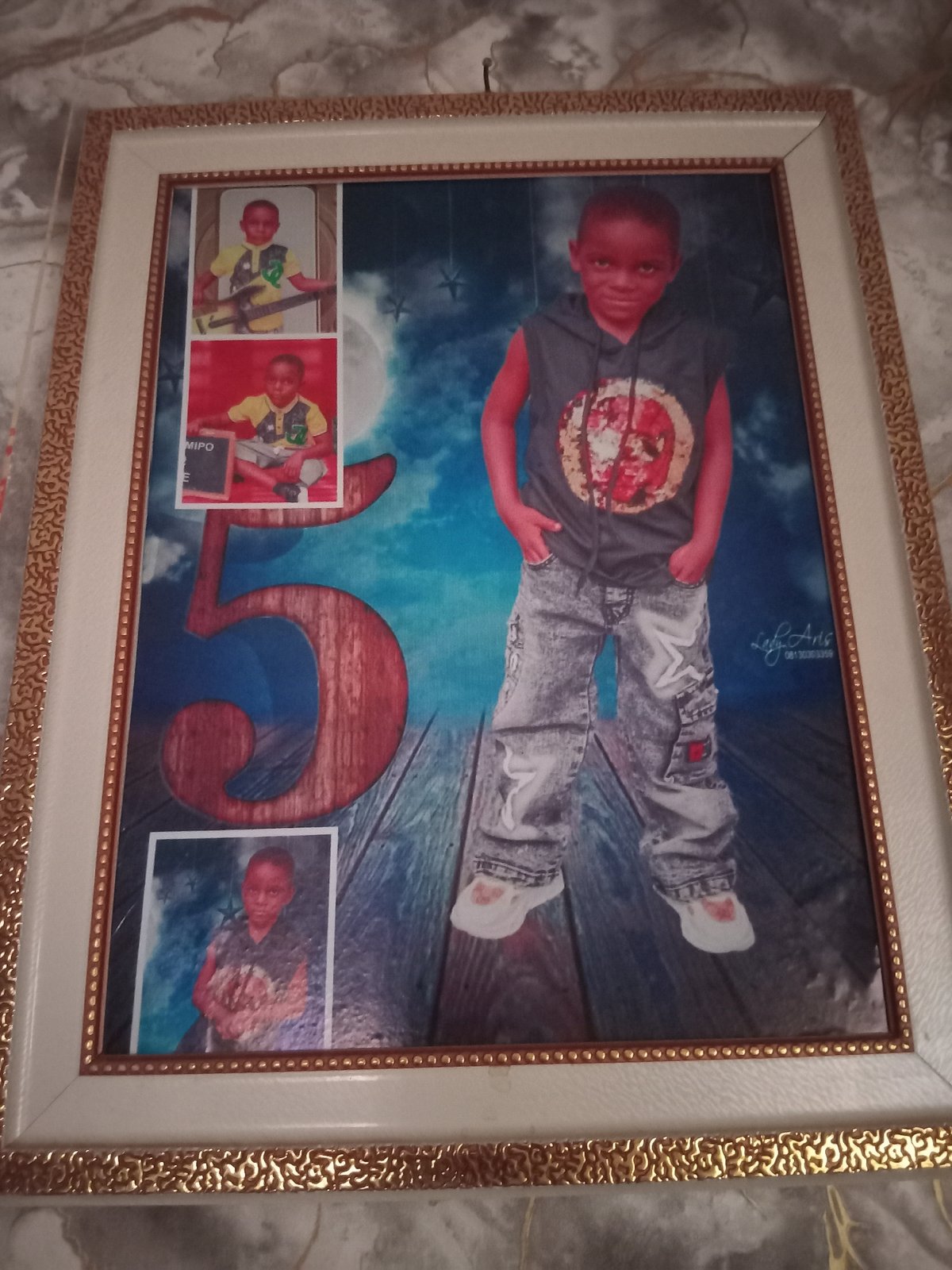 Boy builds cardboard model in decorated room, Shagamu Nigeria