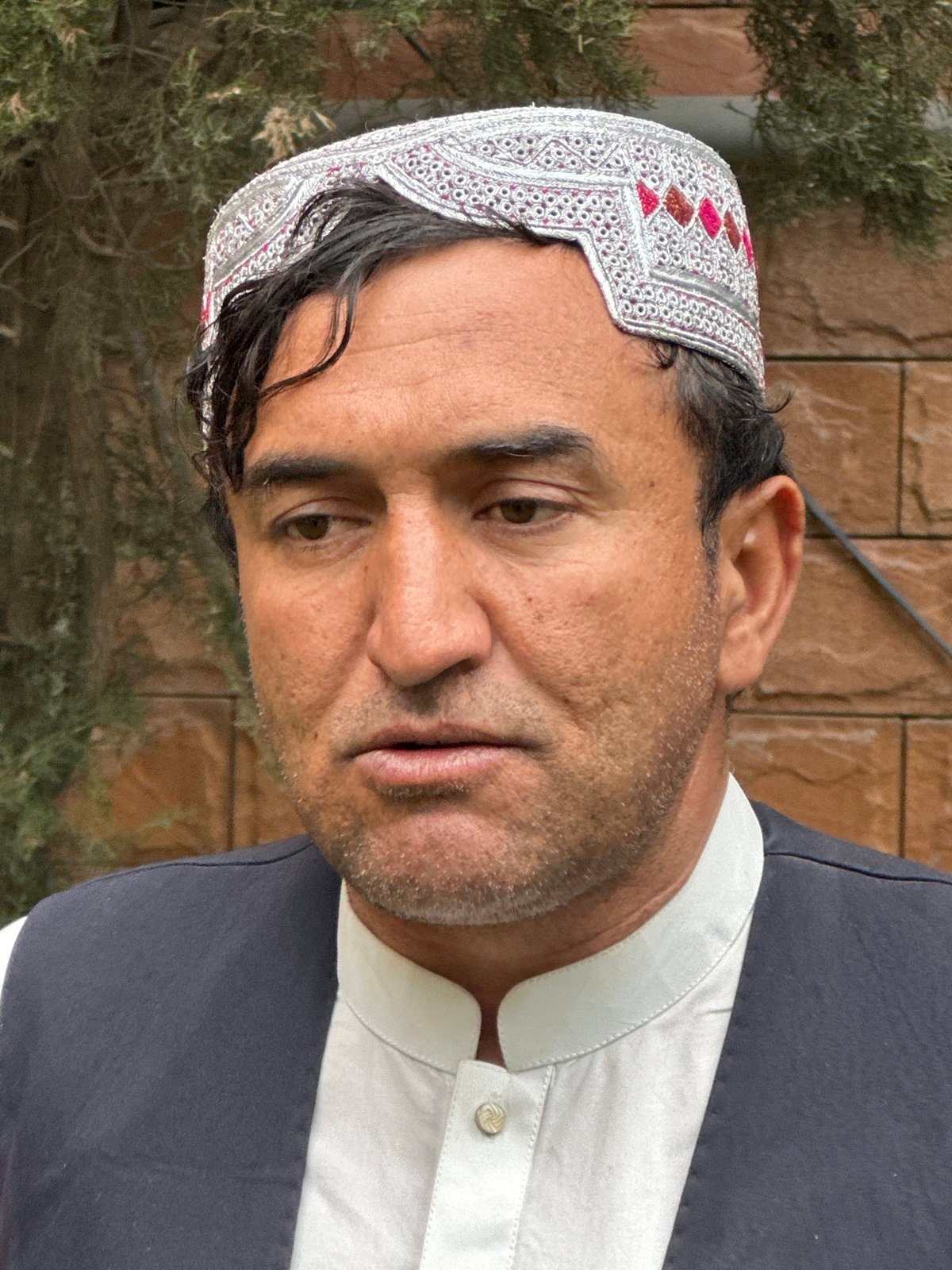 Men in traditional dress gathered for media interview in Quetta