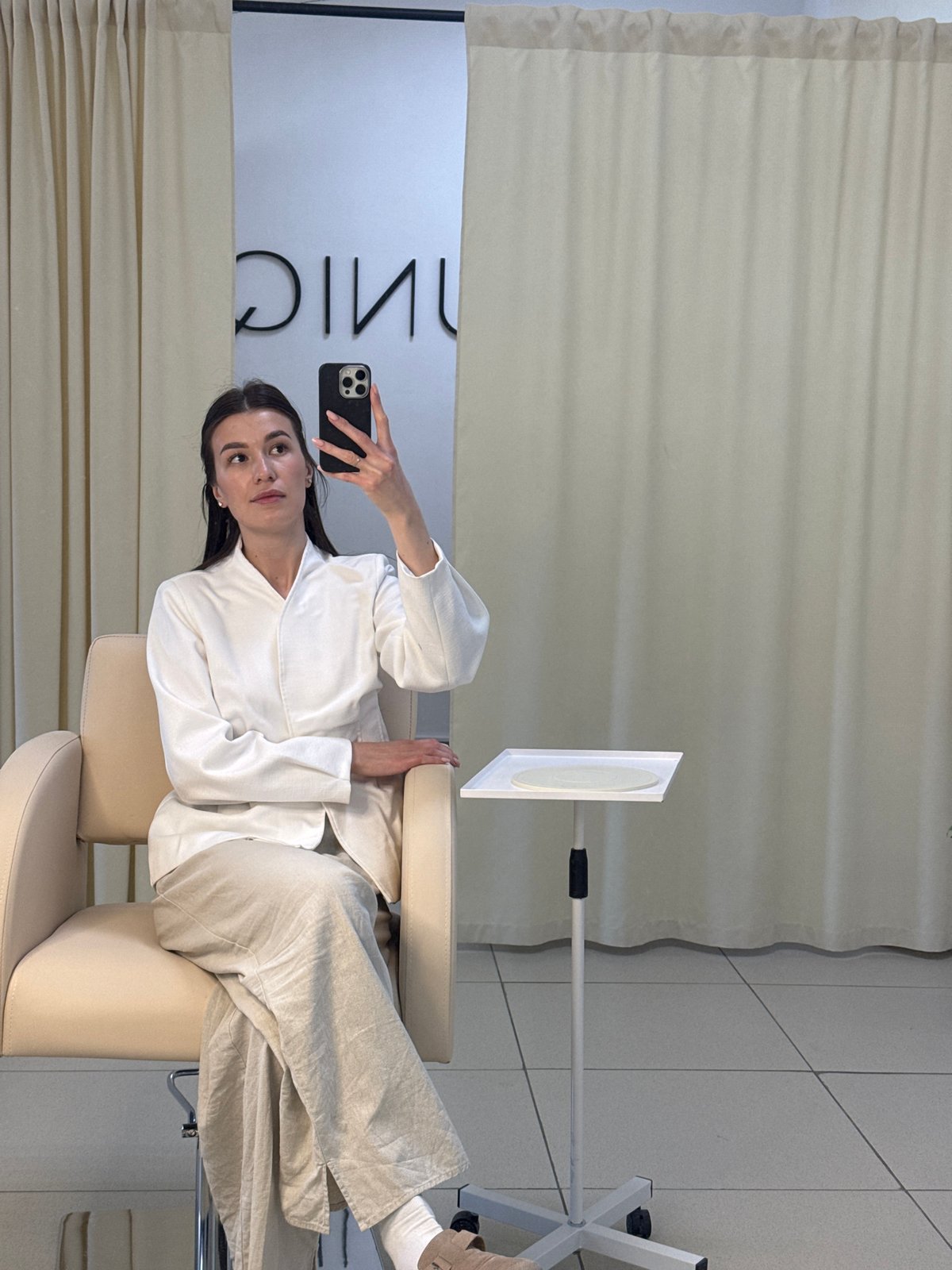 Woman takes selfie in salon chair in Chaikovsky