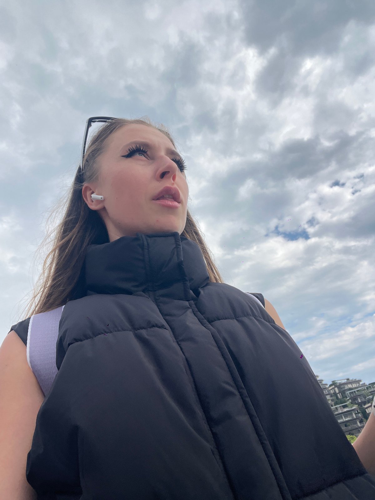 Woman photographed against cloudy skies in coastal Budva