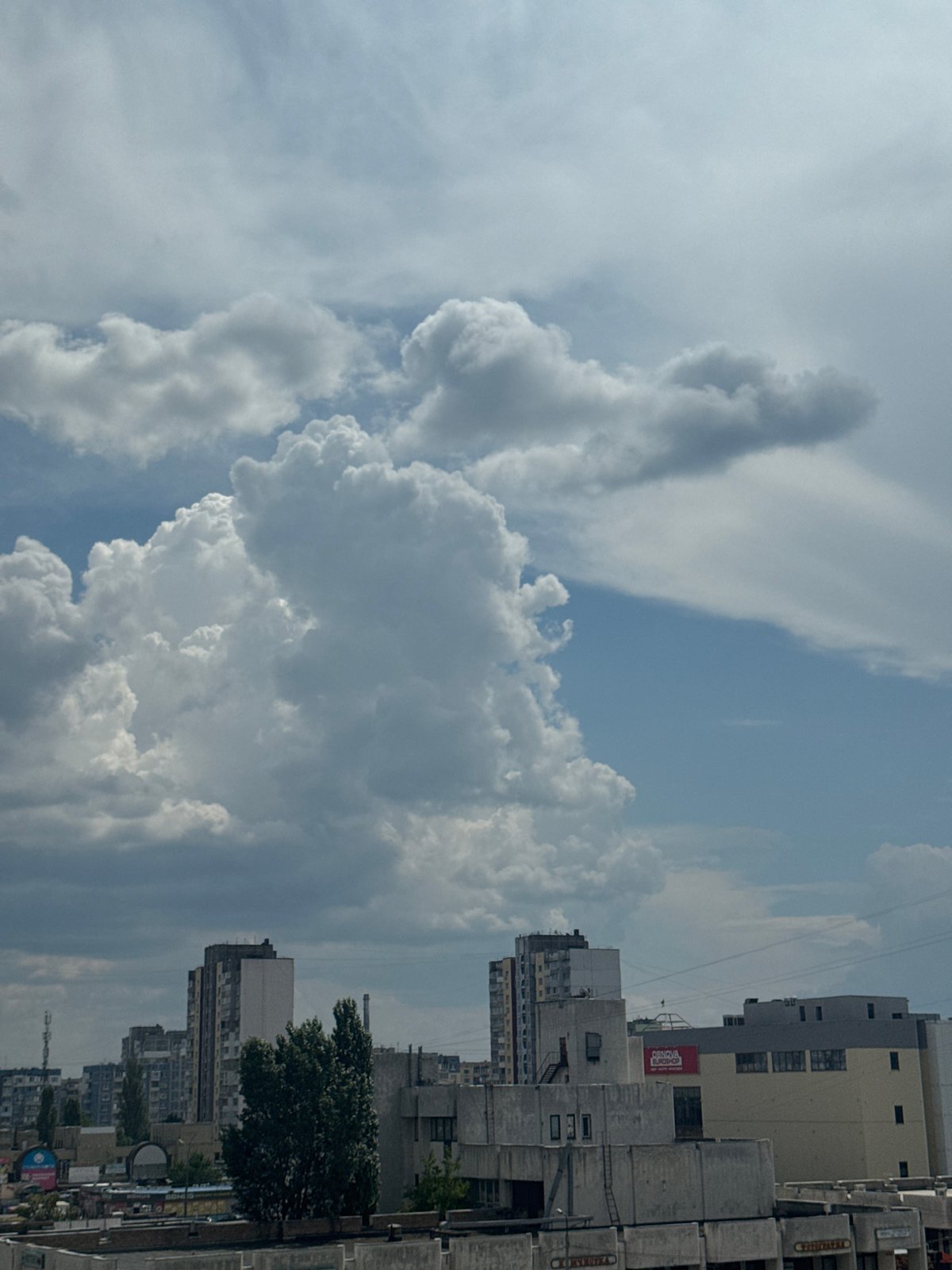 Window views over Kyiv's residential skyline on a summer morning