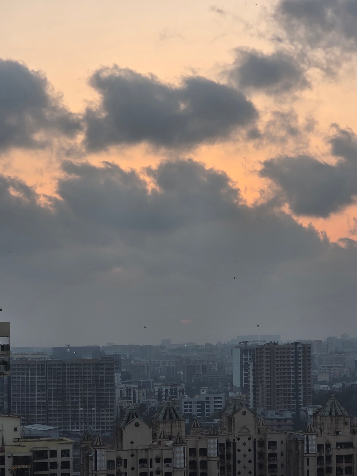Dramatic sky with orange glow observed over Mumbai cityscape