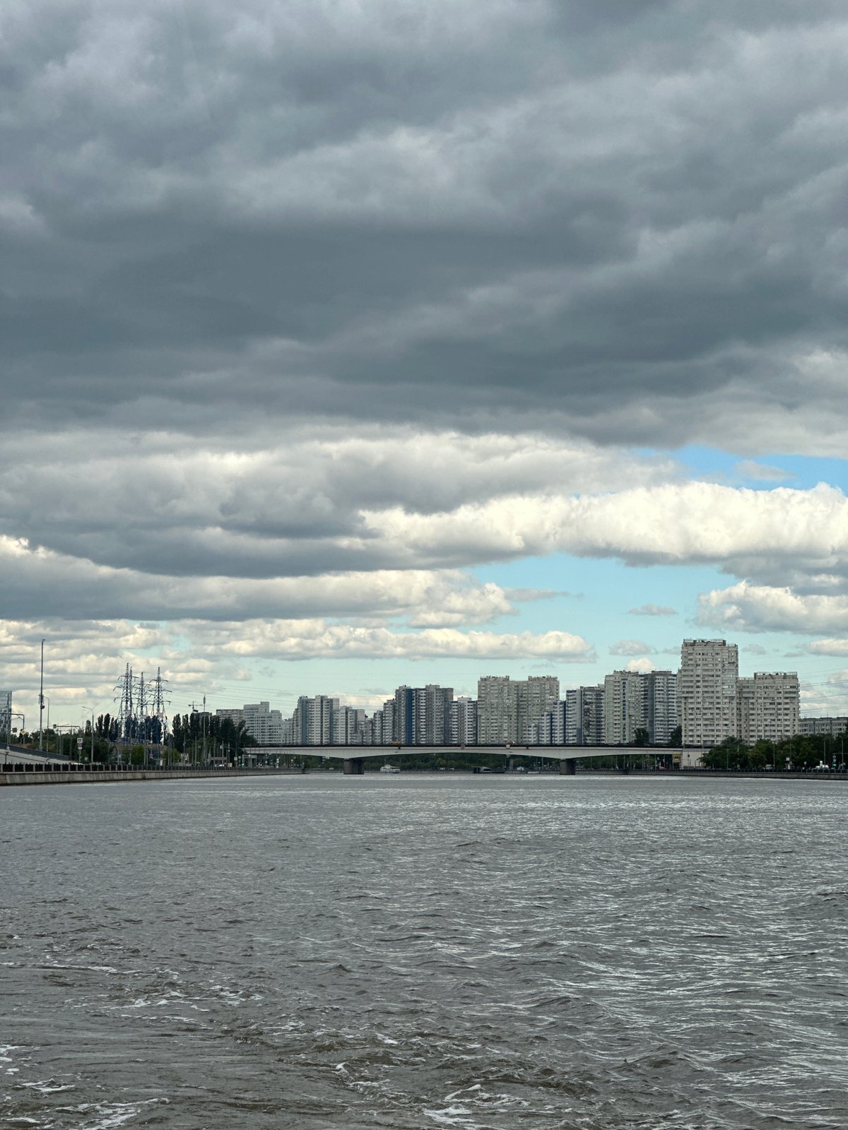 Sleek river boat navigates the Moscow River under overcast skies