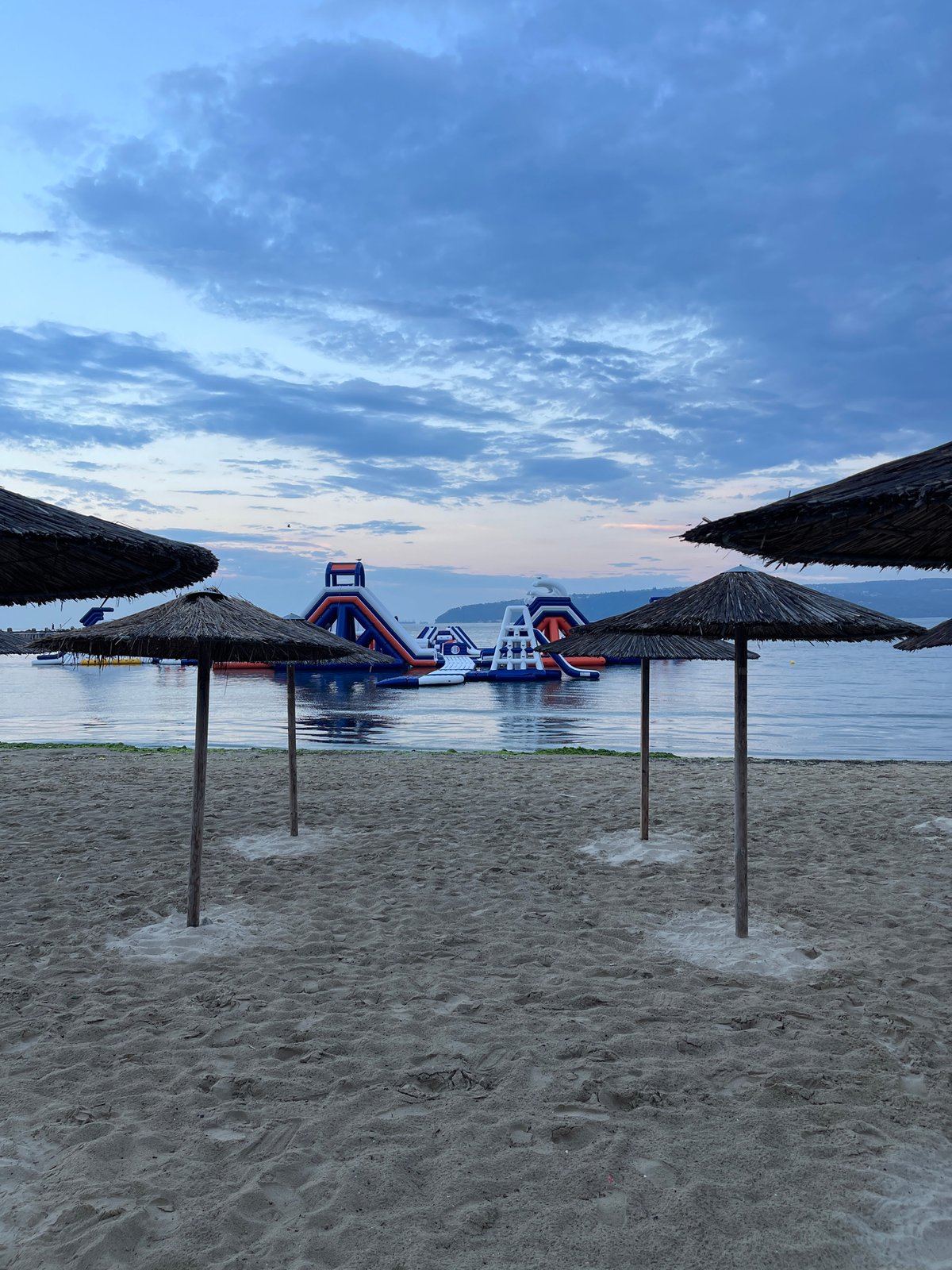 Varna Beach at dusk, inflatable water park offshore