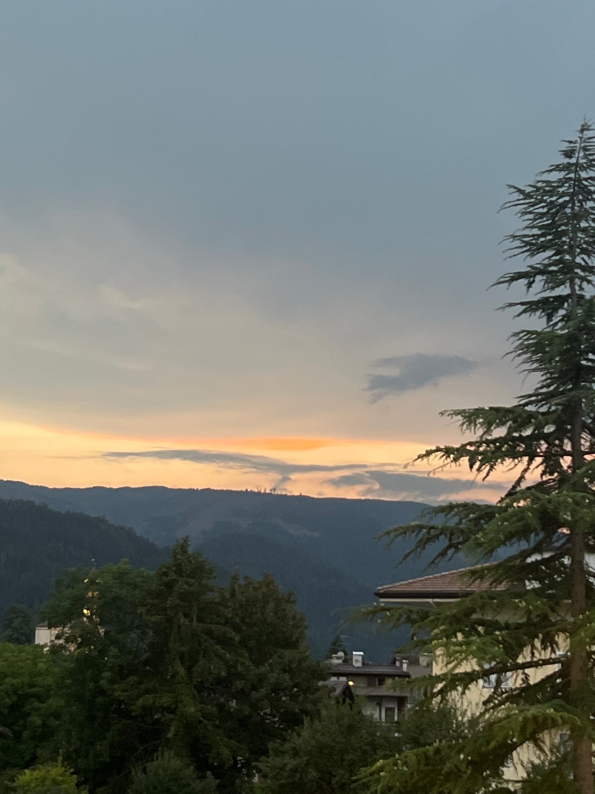 Dusk over Castello di Fiemme, solar panels and Alpine skyline