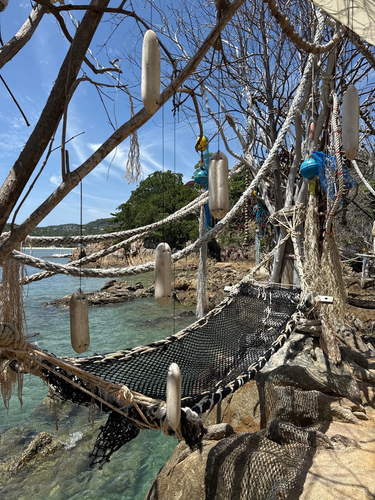 Hammocks, driftwood art, and turquoise water in Ko Pha-ngan