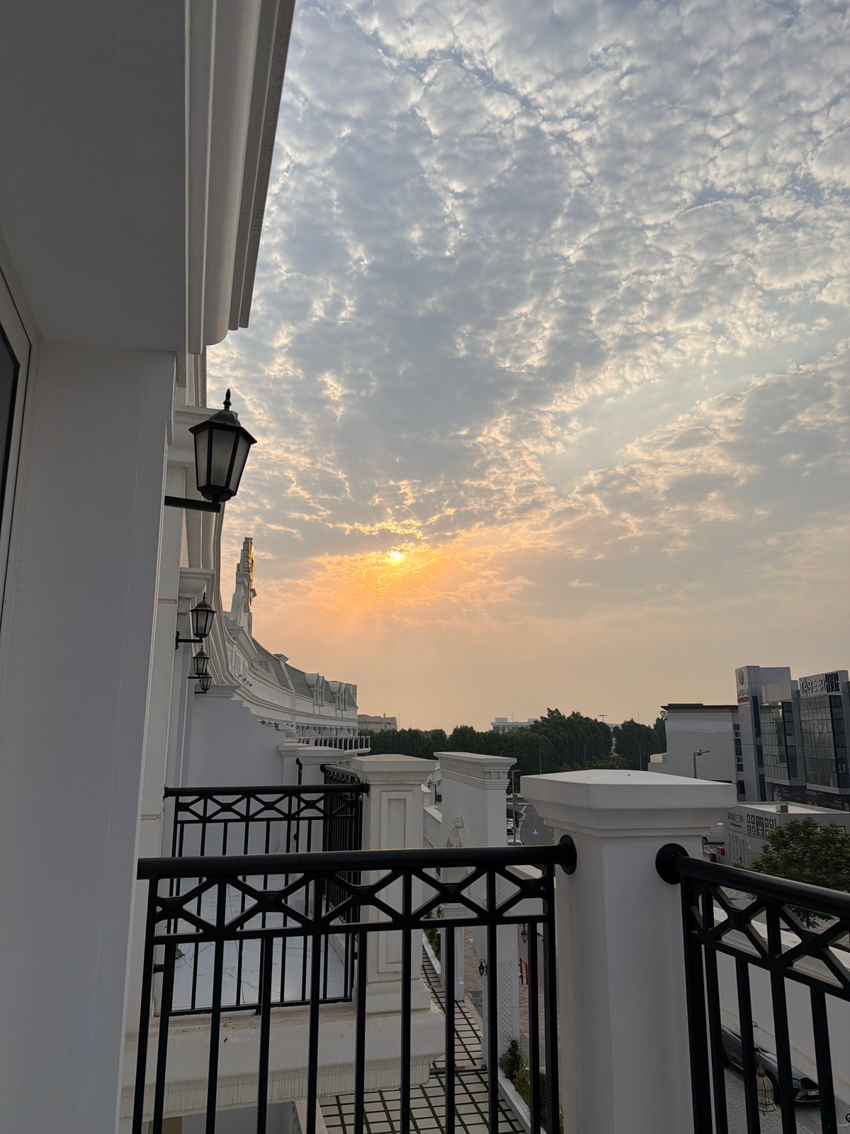 Dubai balcony overlooks cityscape at cloudy sunset