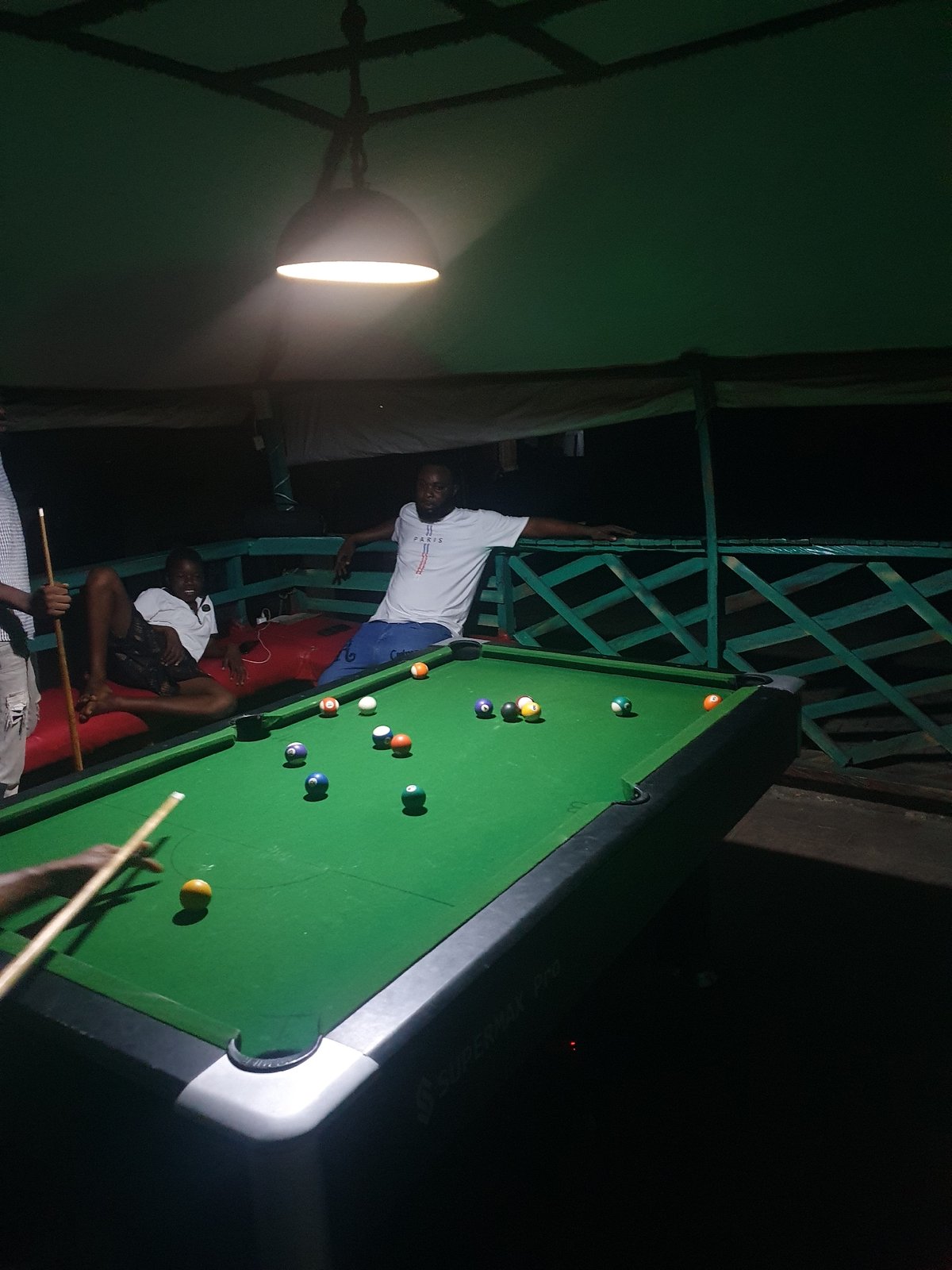 Late-night pool game at an outdoor spot in Lokoja