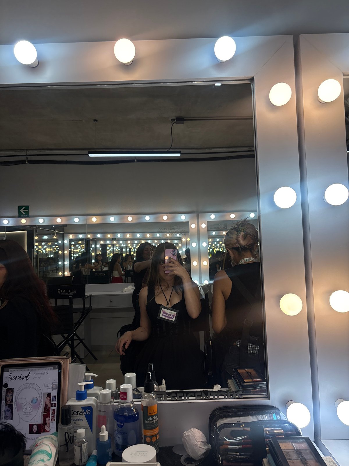 Women photograph themselves at illuminated vanity mirror in Mexico City