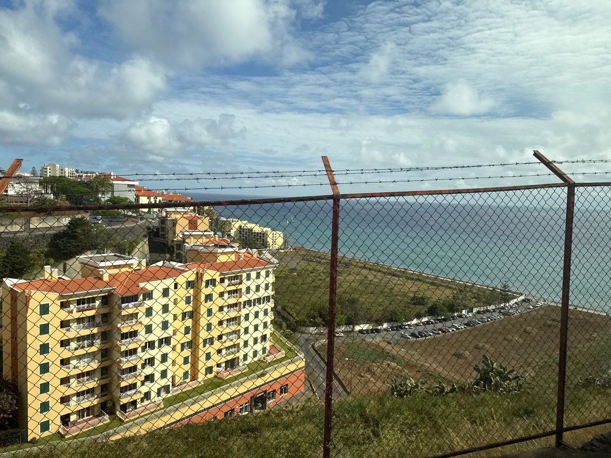 Coastal overlook with yellow building documented in Funchal, Portugal