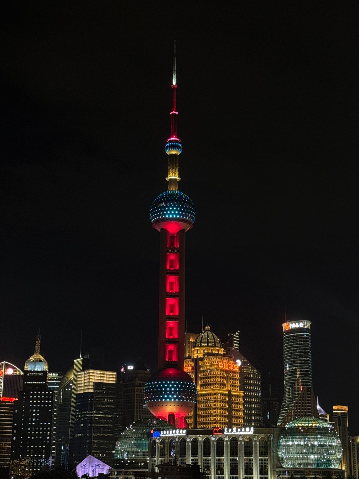 Shanghai's Pudong skyline glowing at night from the Bund