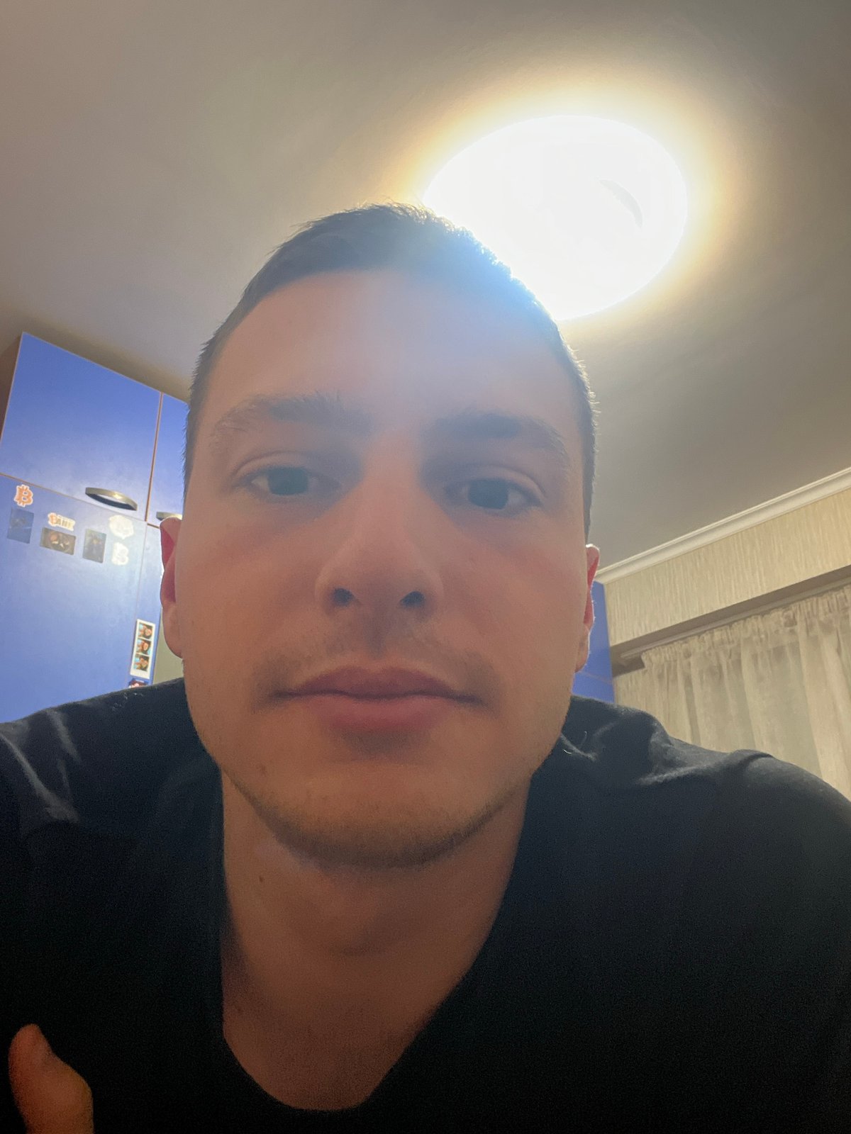 Man takes multiple selfies indoors in Burgas, Bulgaria