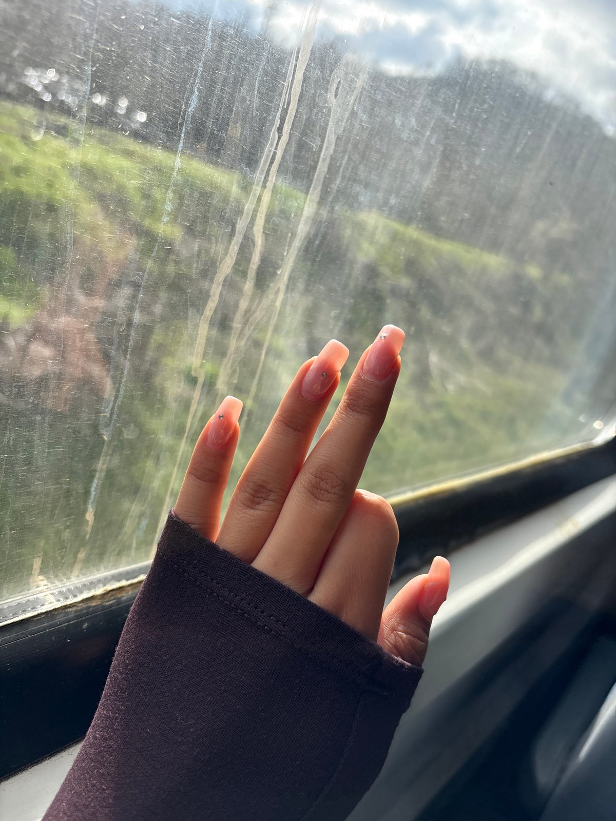 Hand with manicured nails pressed against window in Bulgaria