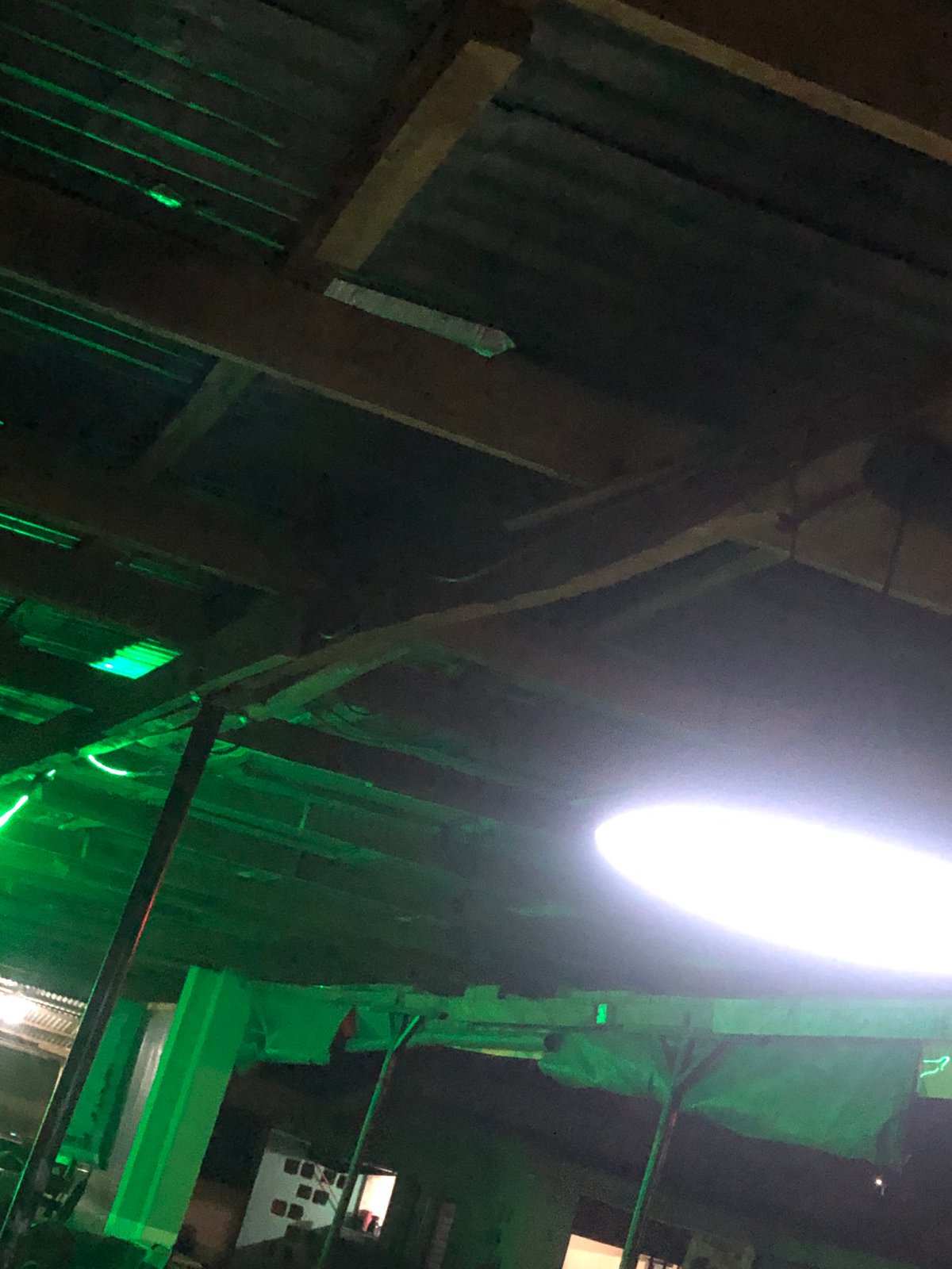 Evening documented between outdoor pool hall and LED-lit residence