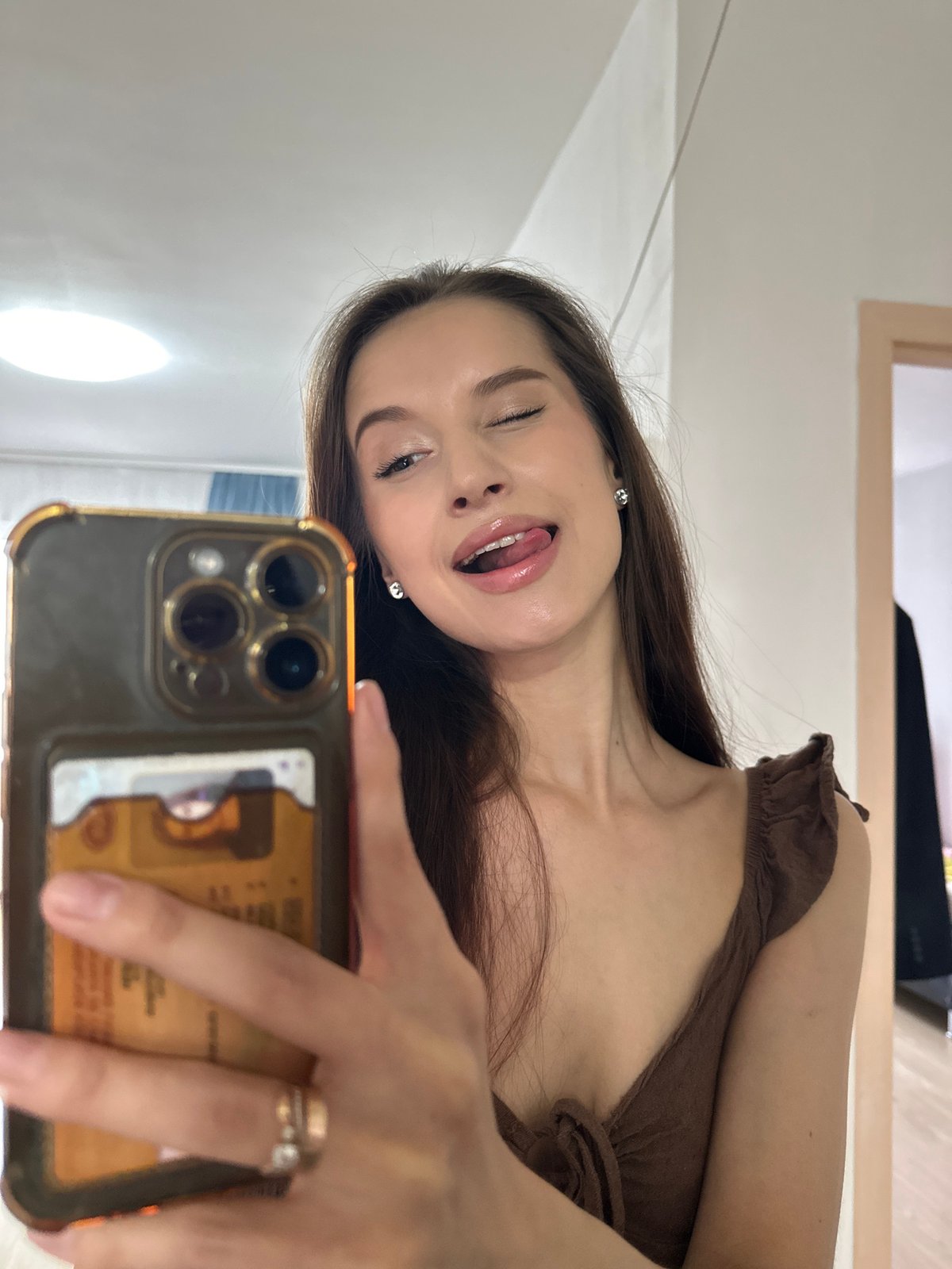 Woman takes playful selfies in Yekaterinburg room