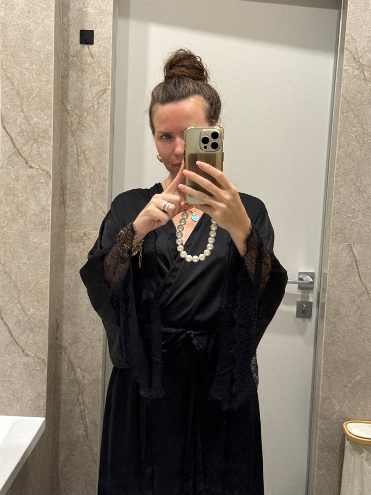 Bathroom mirror selfie in black robe and pearl necklace