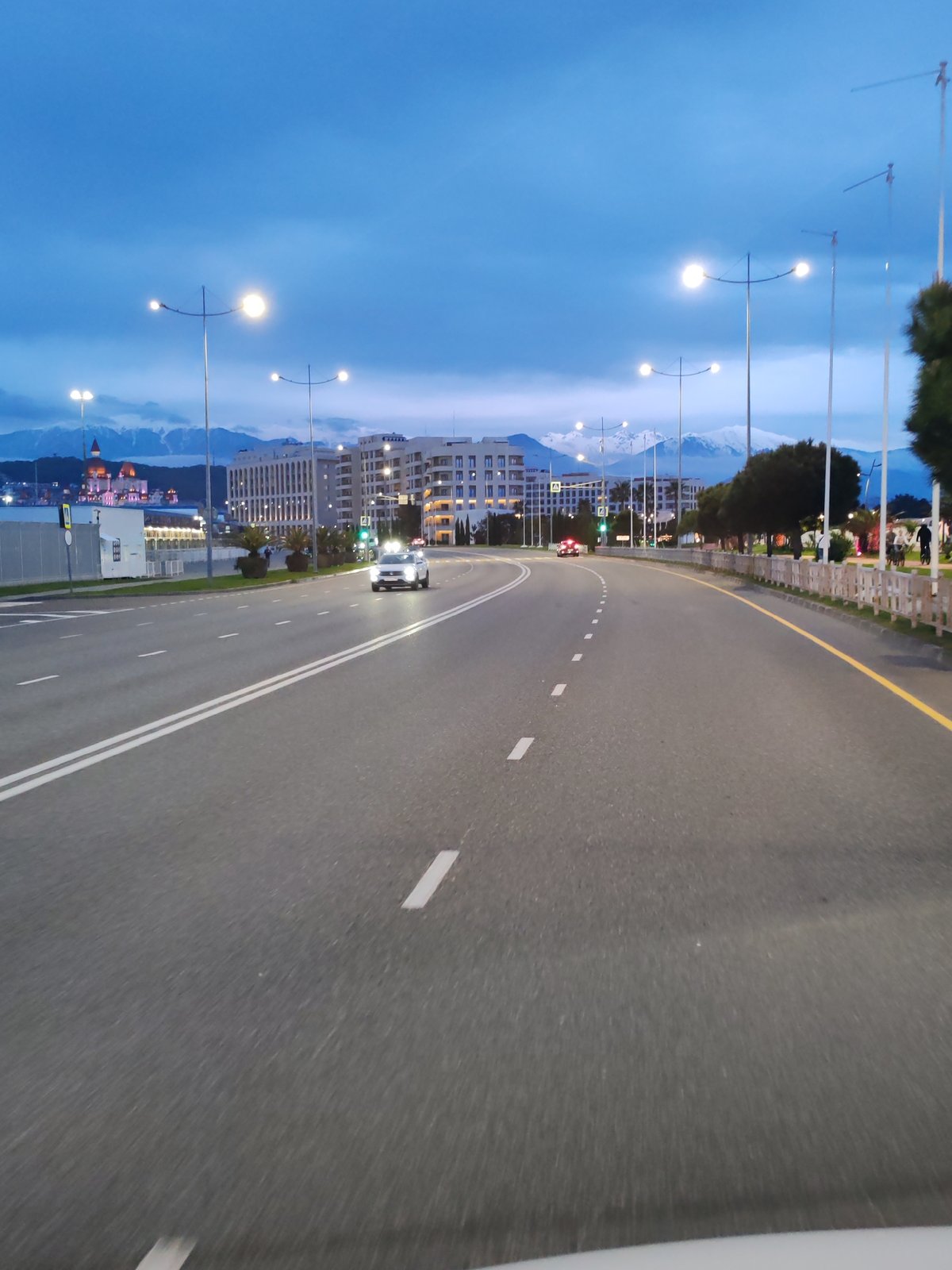 Evening traffic documented on urban road during twilight