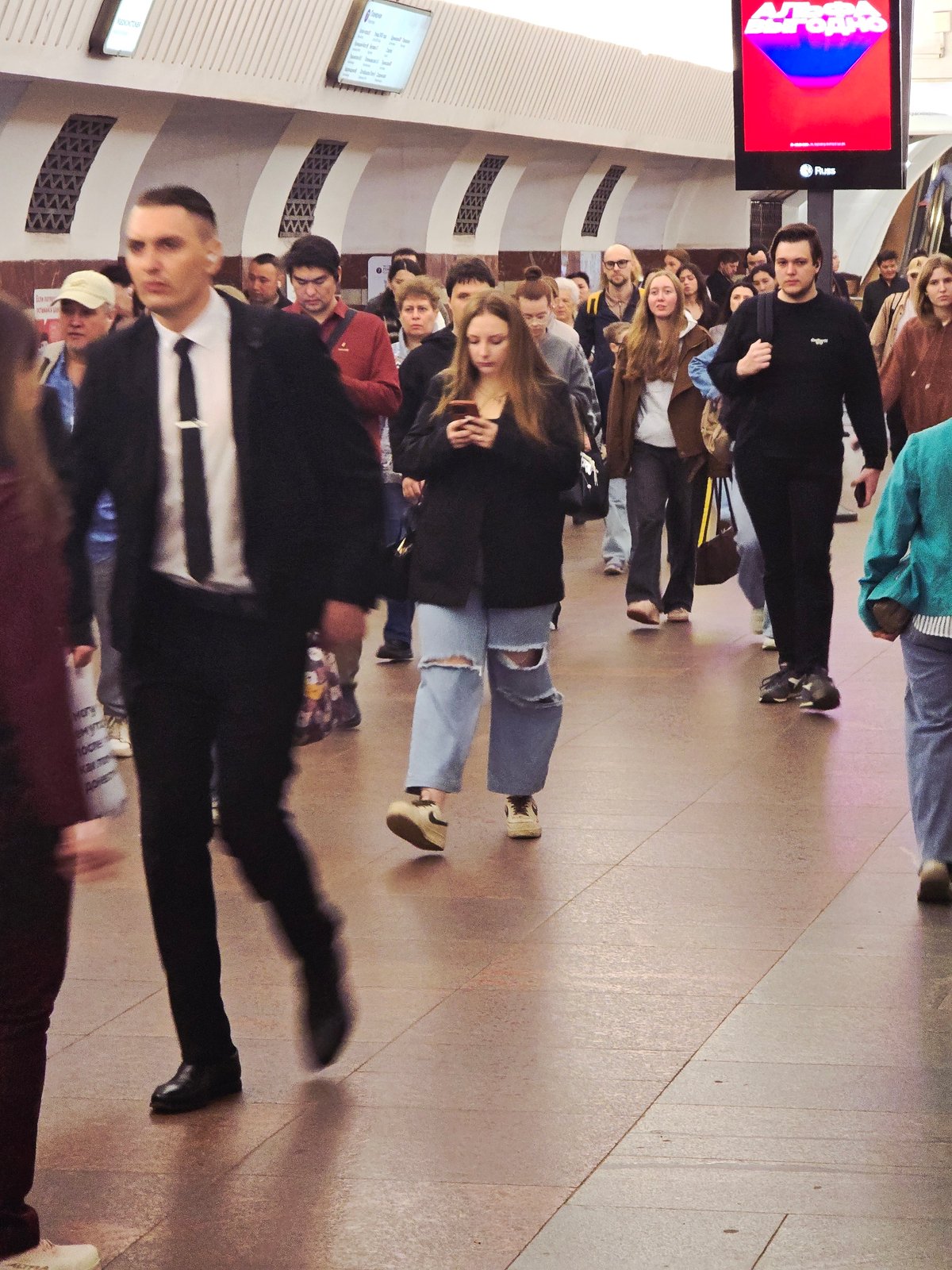 Young adults gather in unidentified underground transit station