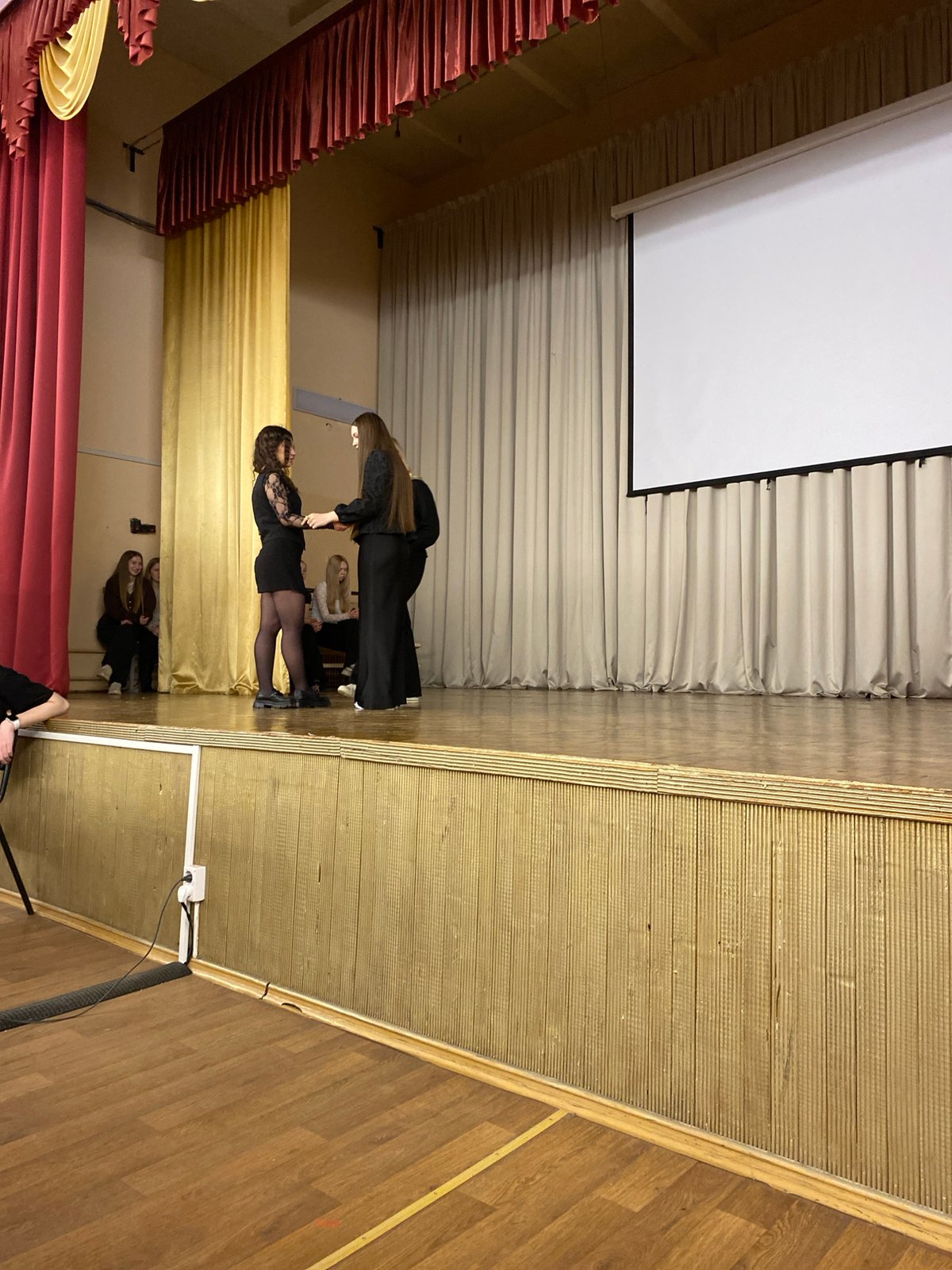 Women perform on stage in Votkinsk auditorium early morning