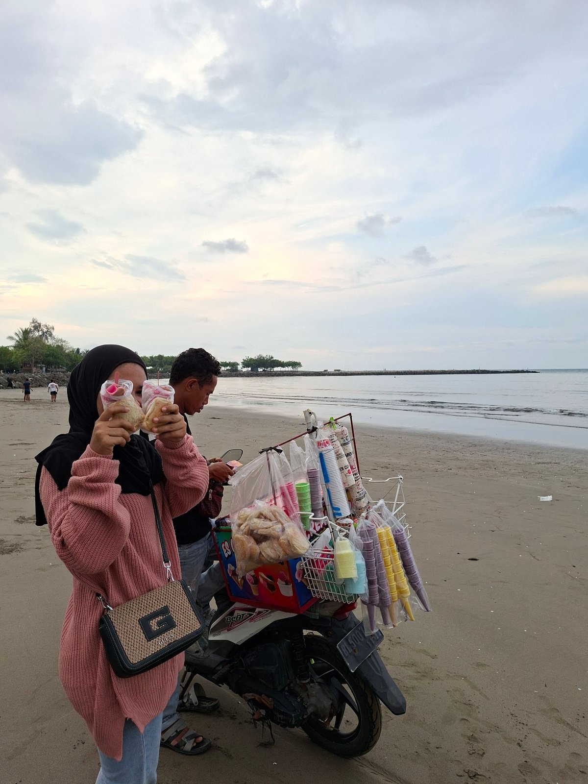 Beach ice cream vendor serves customers in Lhokseumawe