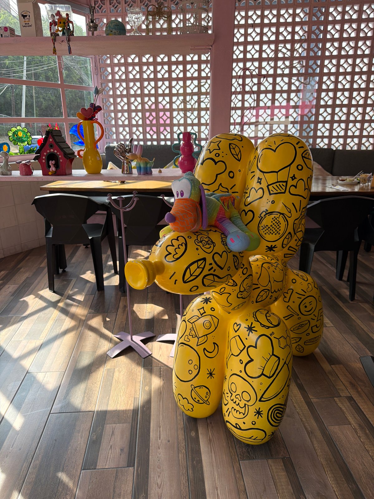 Colorful cafe interior with yellow sculpture documented in Puebla