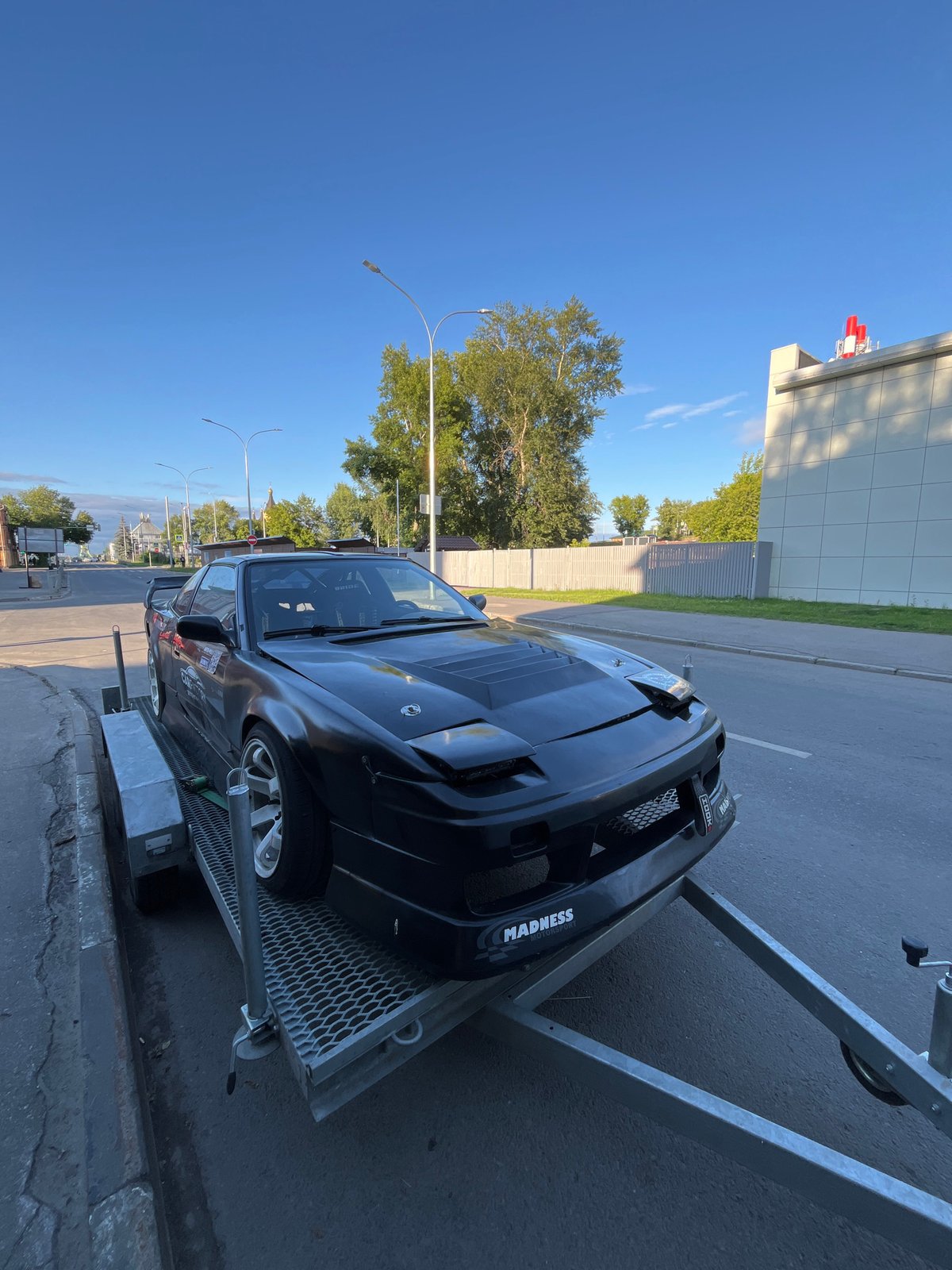 Beaten-up drift S13 strapped to a trailer in Nizhny Novgorod