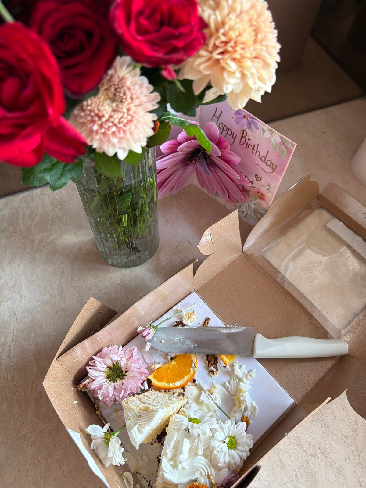 Woman documents breakfast with flowers in Mengwi kitchen
