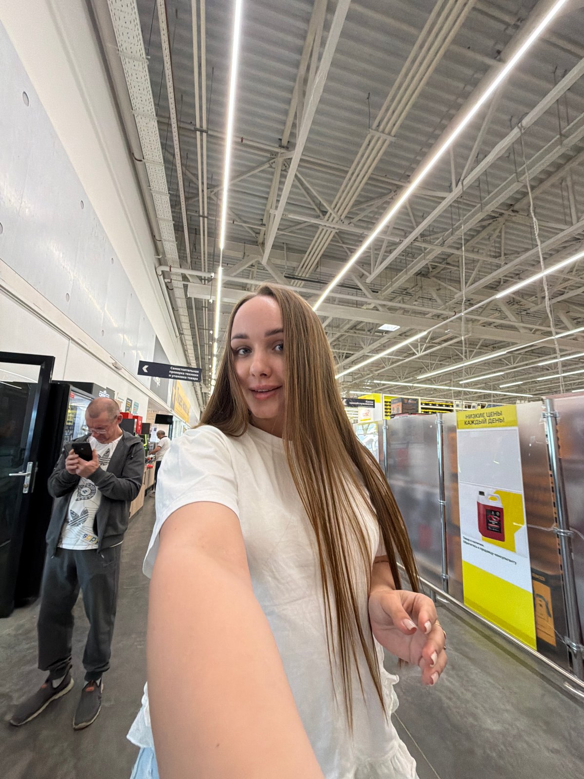 Woman documents shopping trip at Izhevsk warehouse store