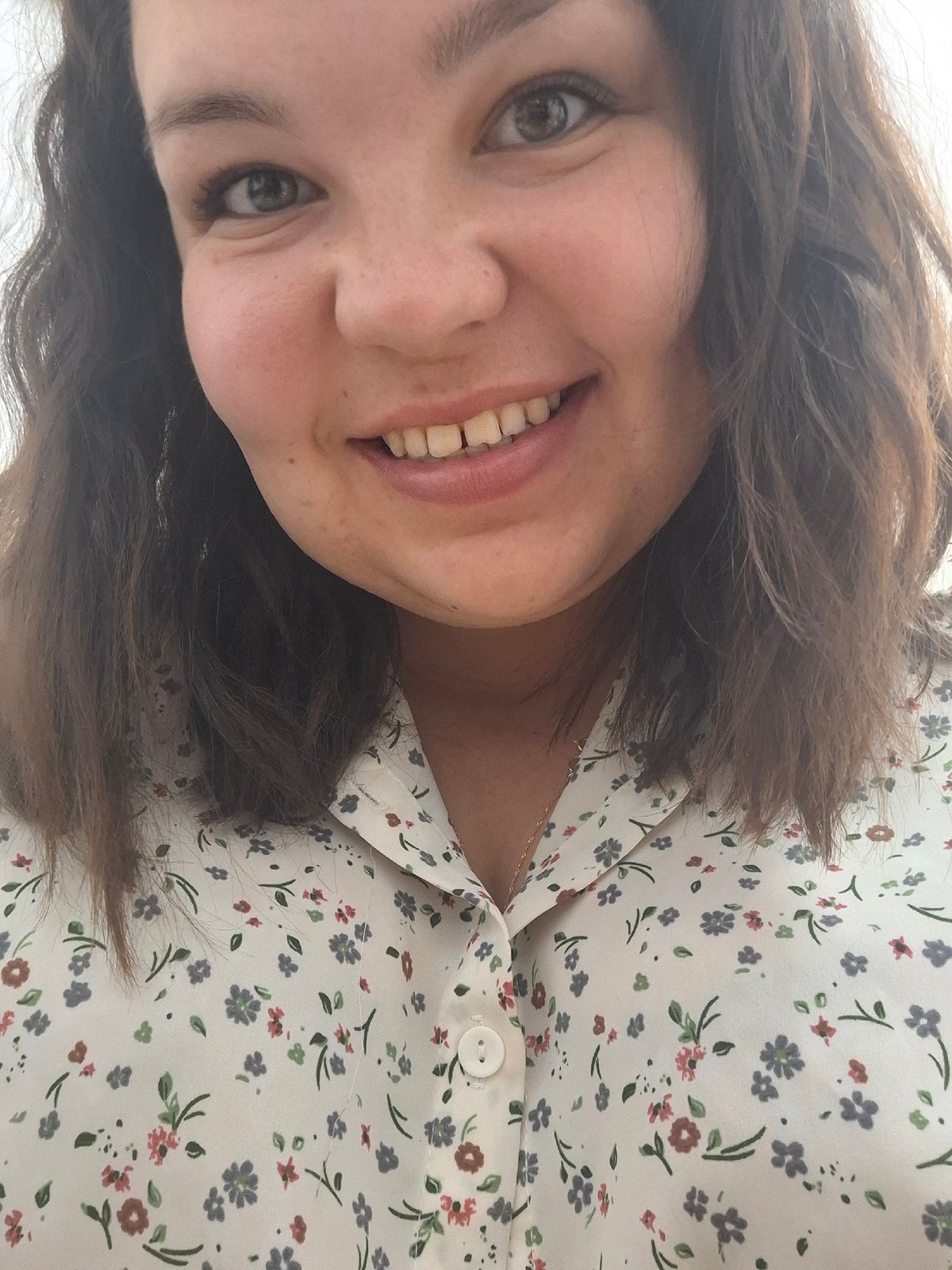 Woman in floral blouse photographed smiling in Markovskii